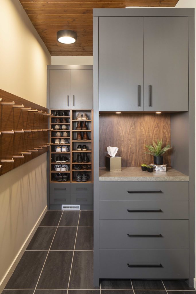 A contemporary walk-in closet with farmhouse-inspired shelves and drawers.