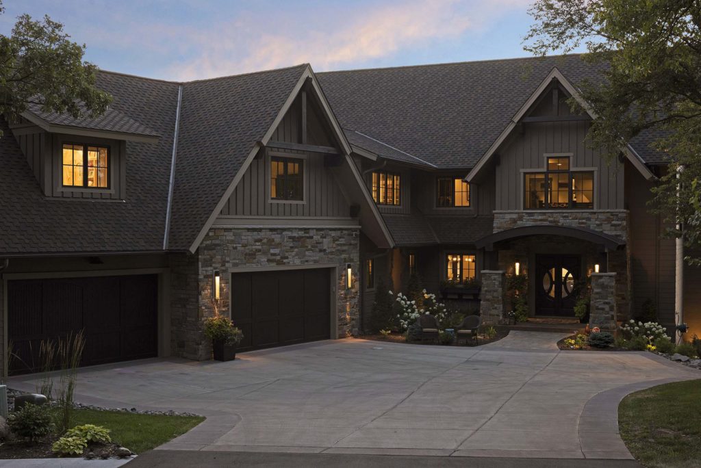 A home with a driveway and garage at dusk.