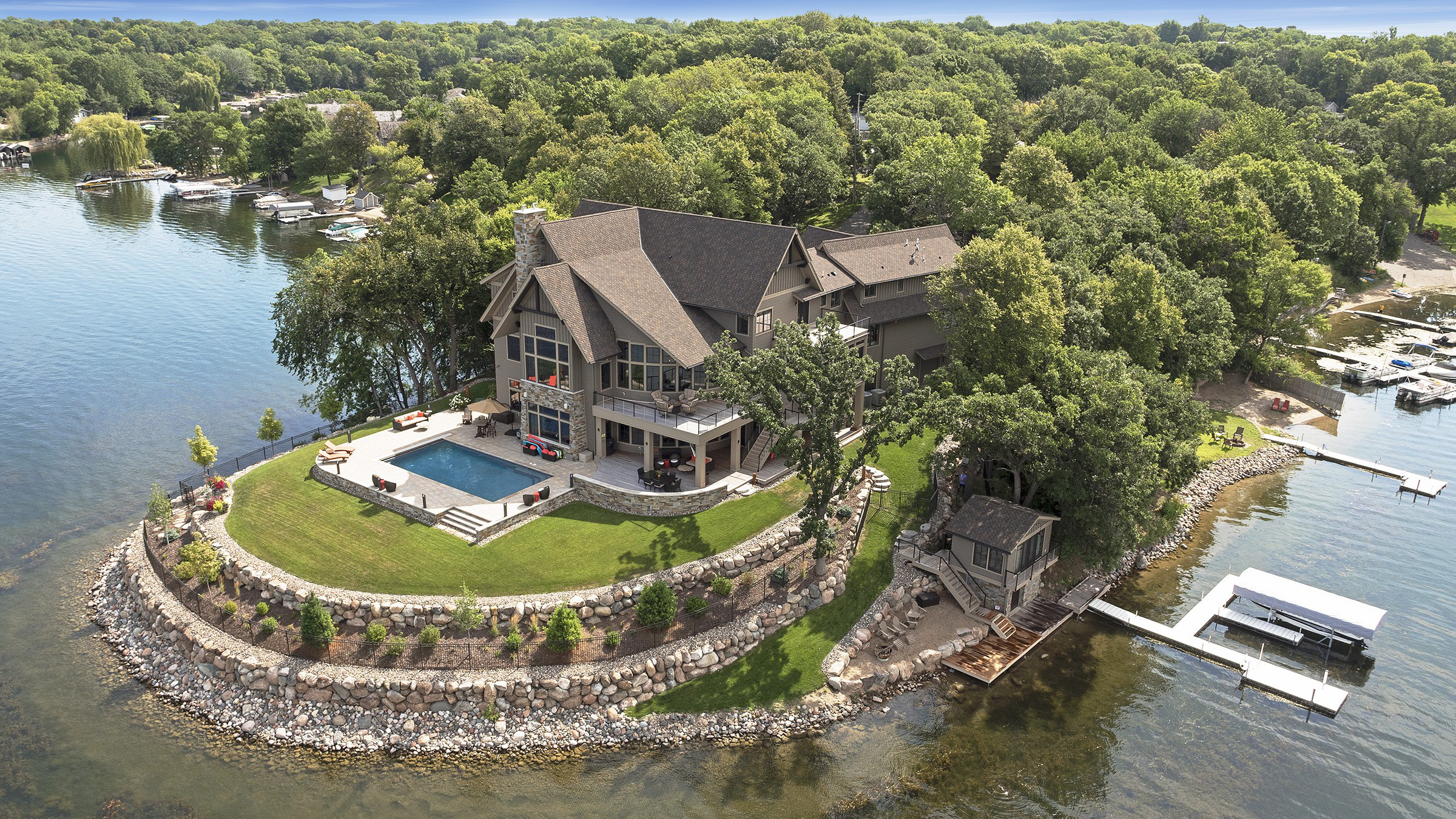 An aerial view of a contemporary home on a lake.