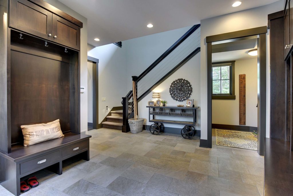 An entryway with a bench and stairs.