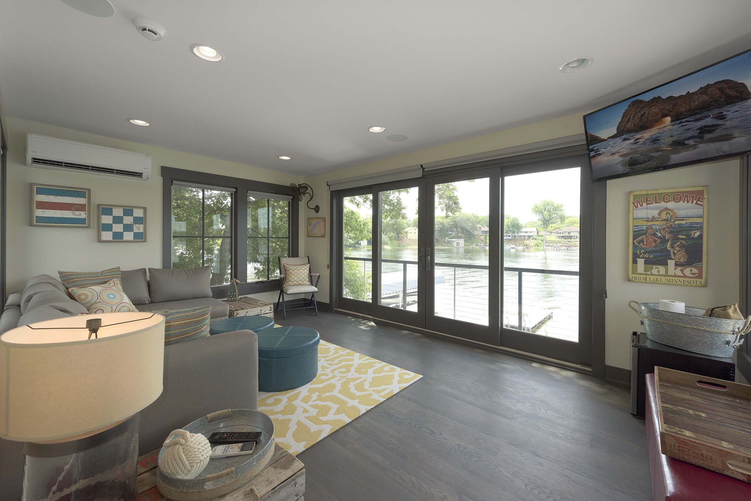 A living room with sliding glass doors and a flat screen tv.