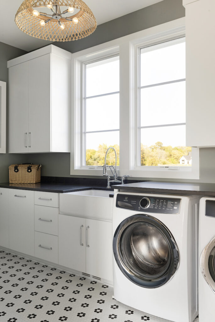 A prairie transitional custom home with a laundry room equipped with a washer and dryer.