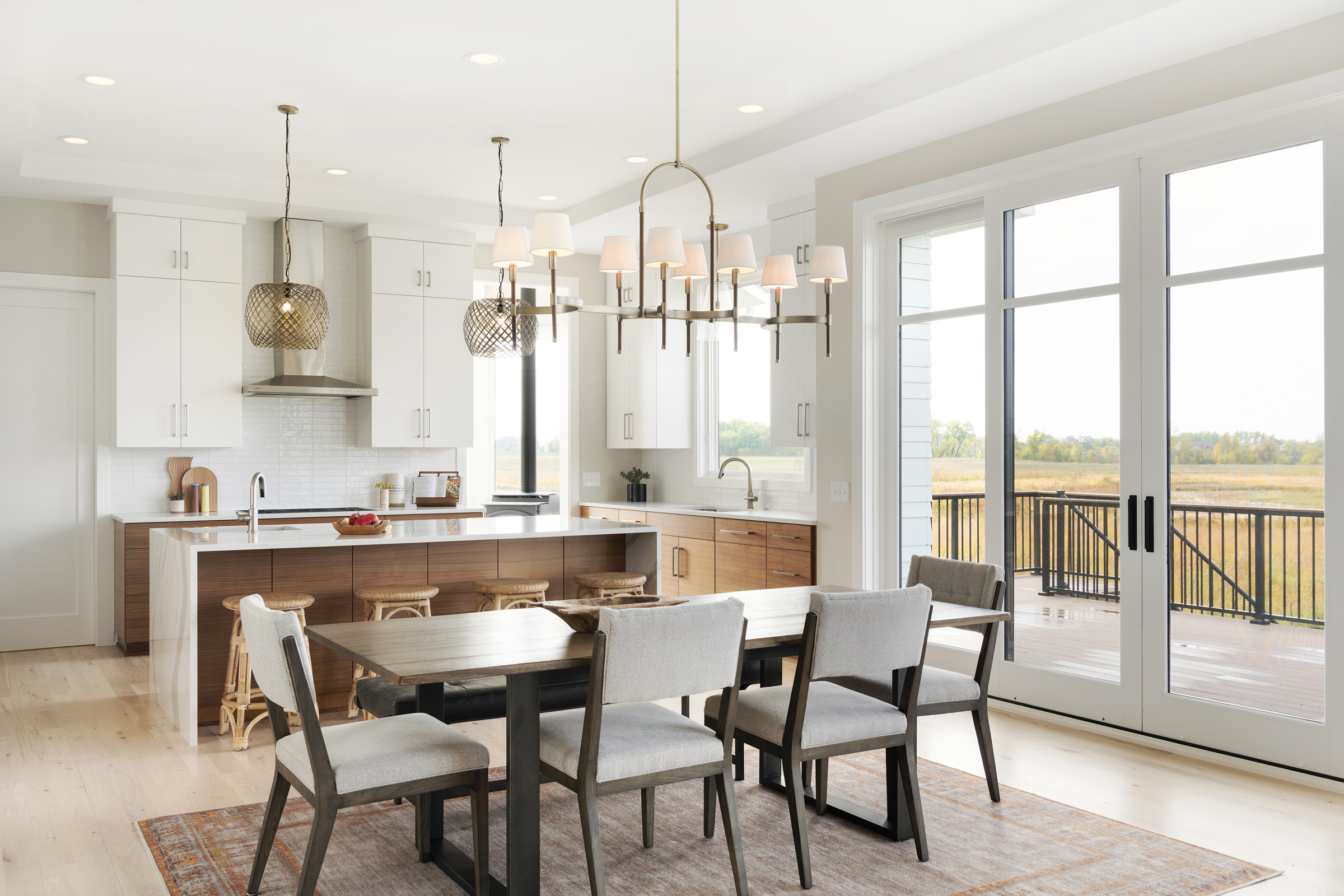 A custom kitchen in a prairie transitional home, complete with a spacious dining table and chairs.