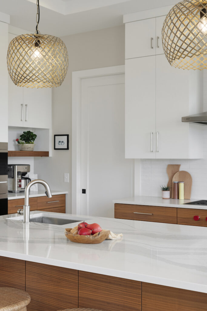 A prairie transitional custom home featuring a white kitchen with wooden counter tops.