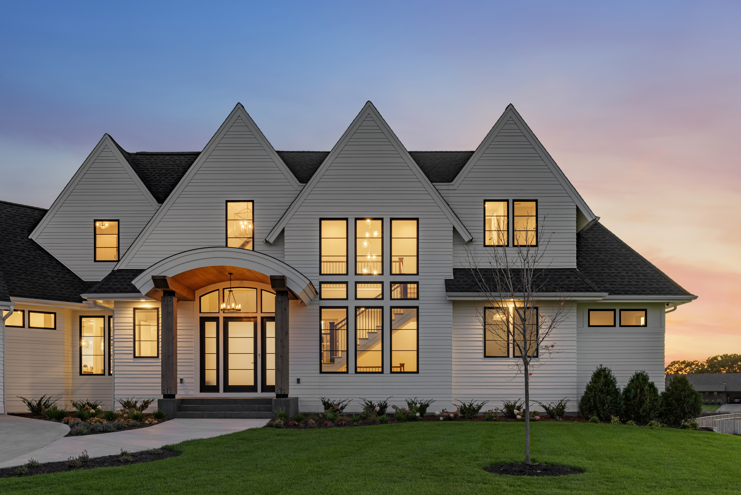 The exterior of a prairie transitional custom home at dusk.