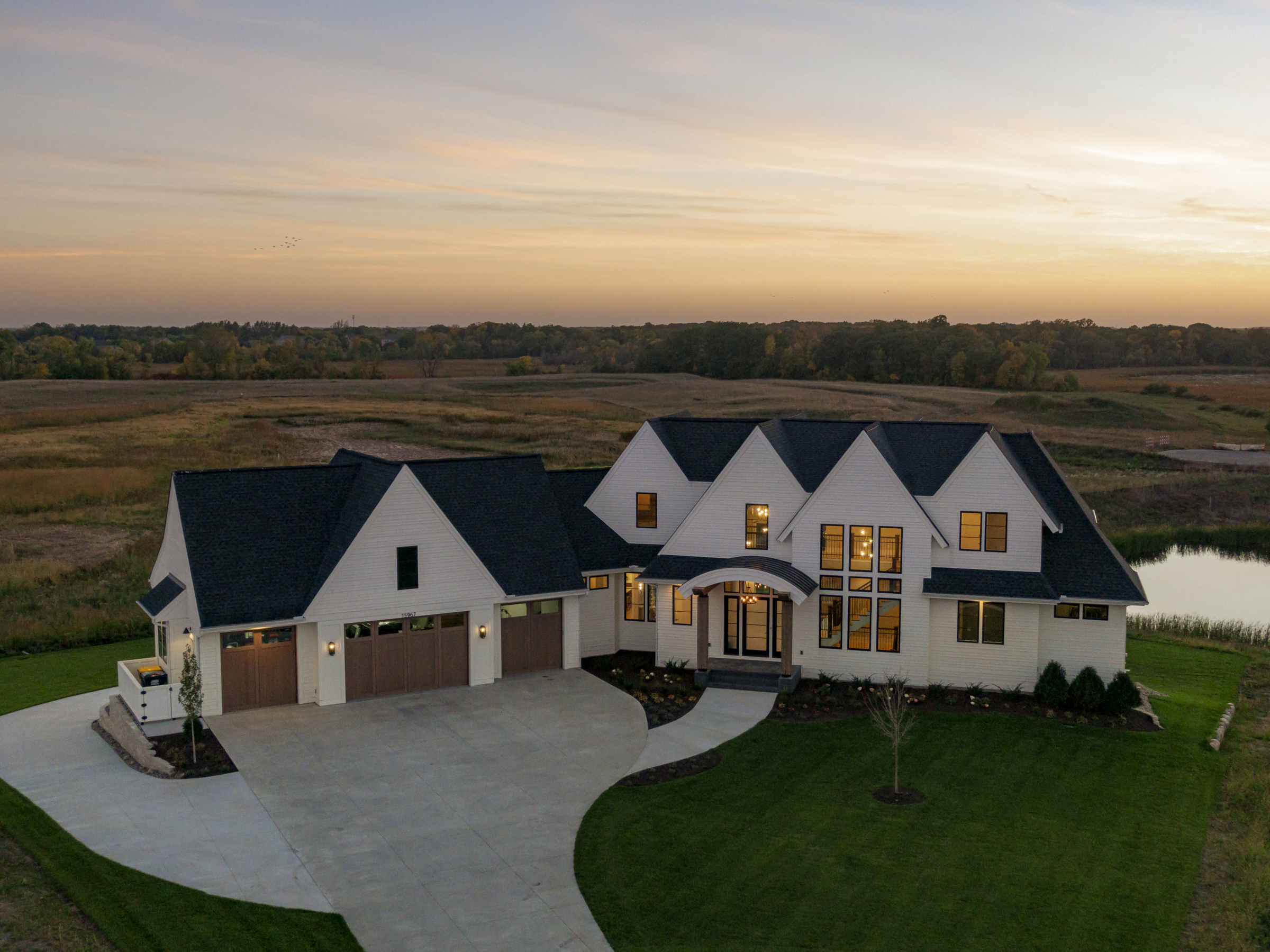 An aerial view of a prairie home in the countryside.