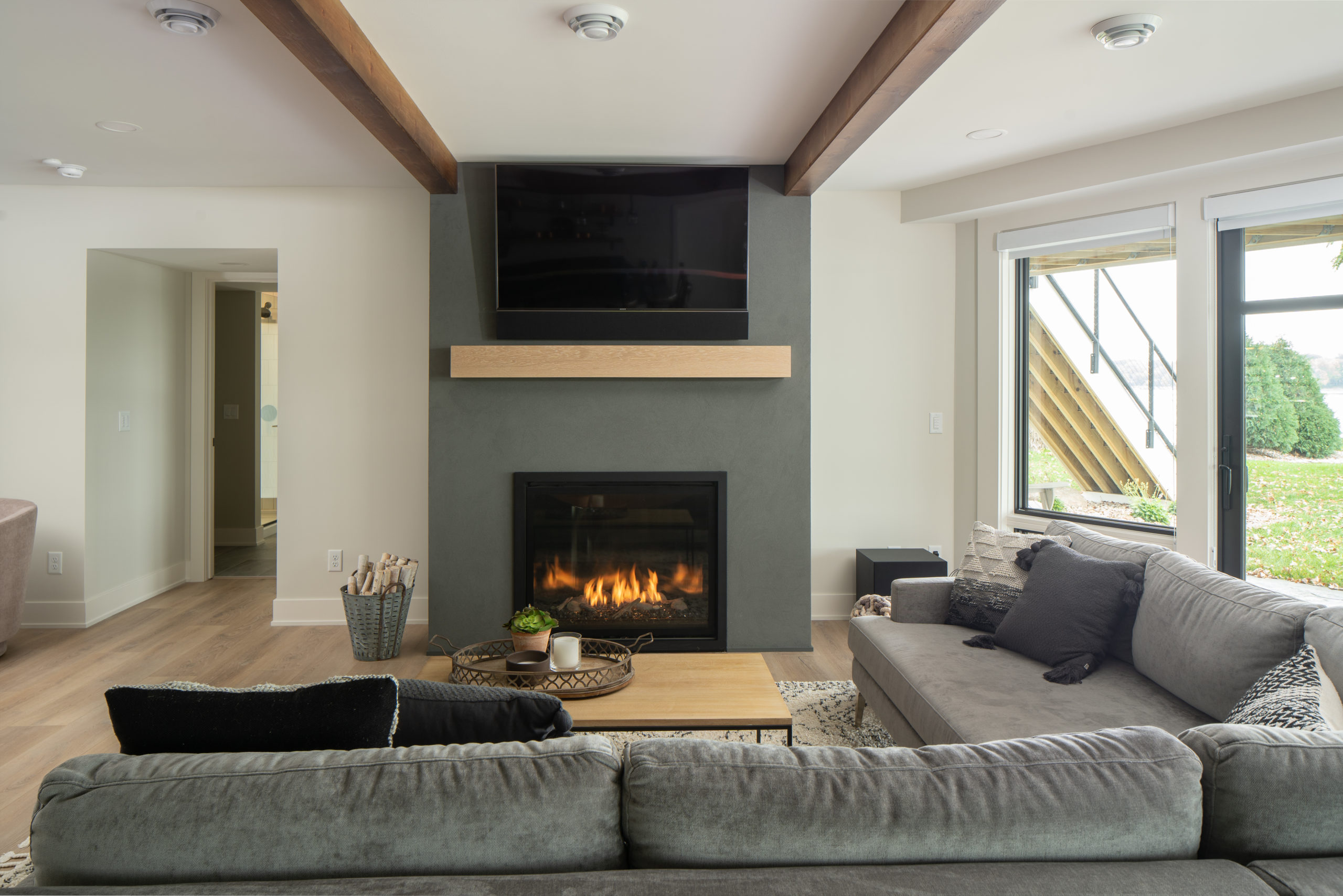 The Lake Escape custom home remodel enhanced with a cozy fireplace in the living room.