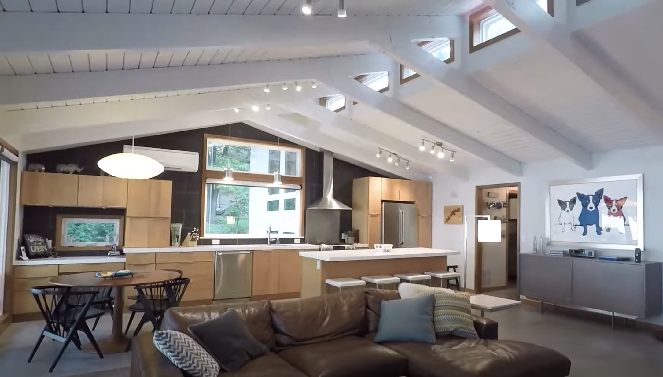 A custom home build video series showcasing a stunning living room and kitchen with vaulted ceilings.
