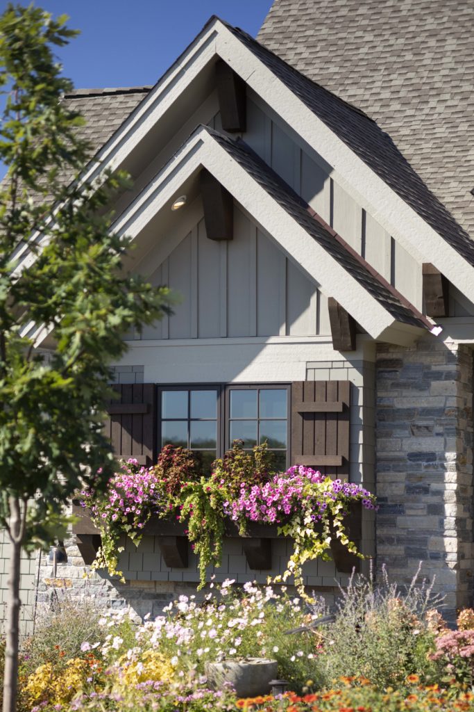 A prairie-style house with a flower box in front of it.