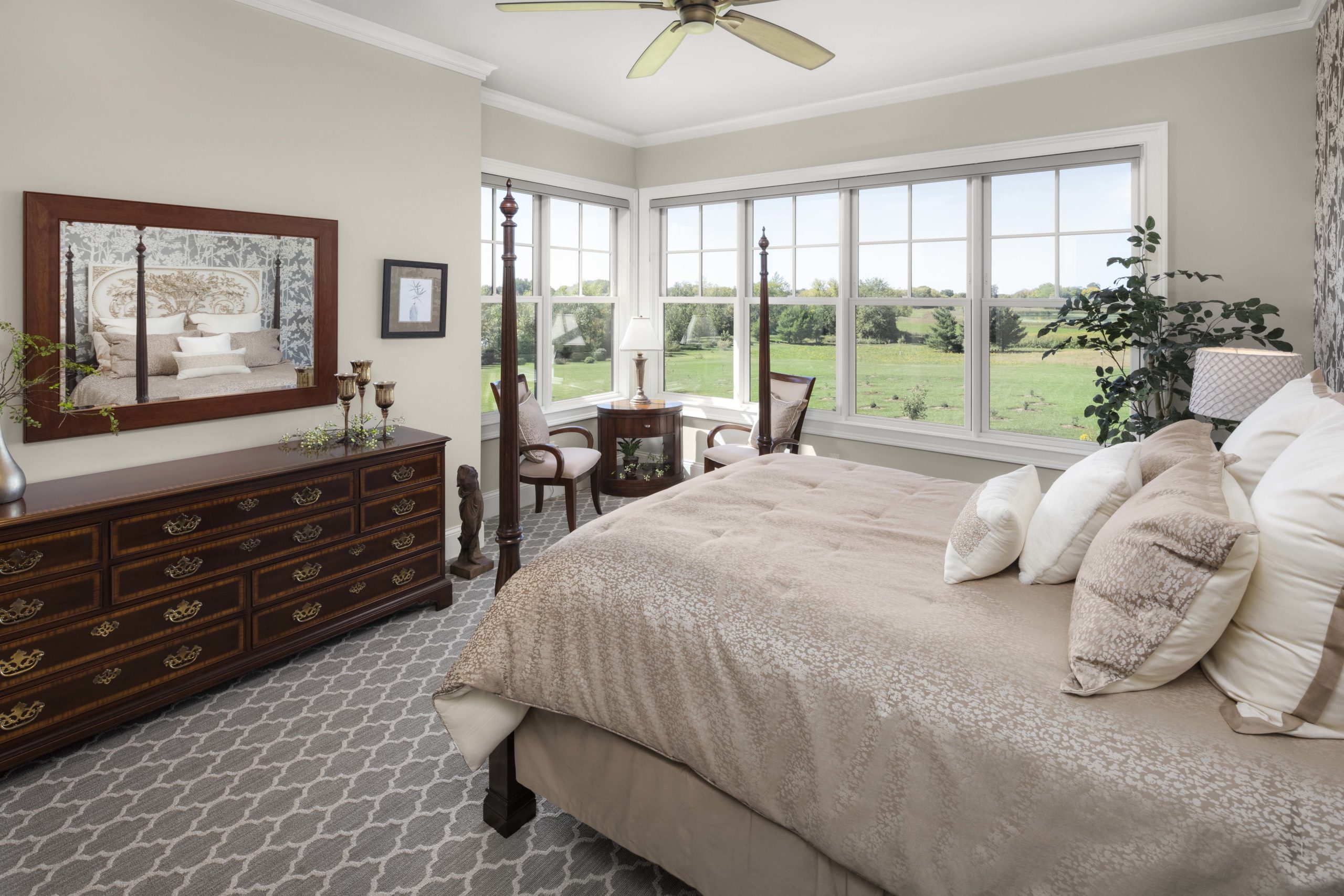 A prairie transitional bedroom with a bed and dresser.
