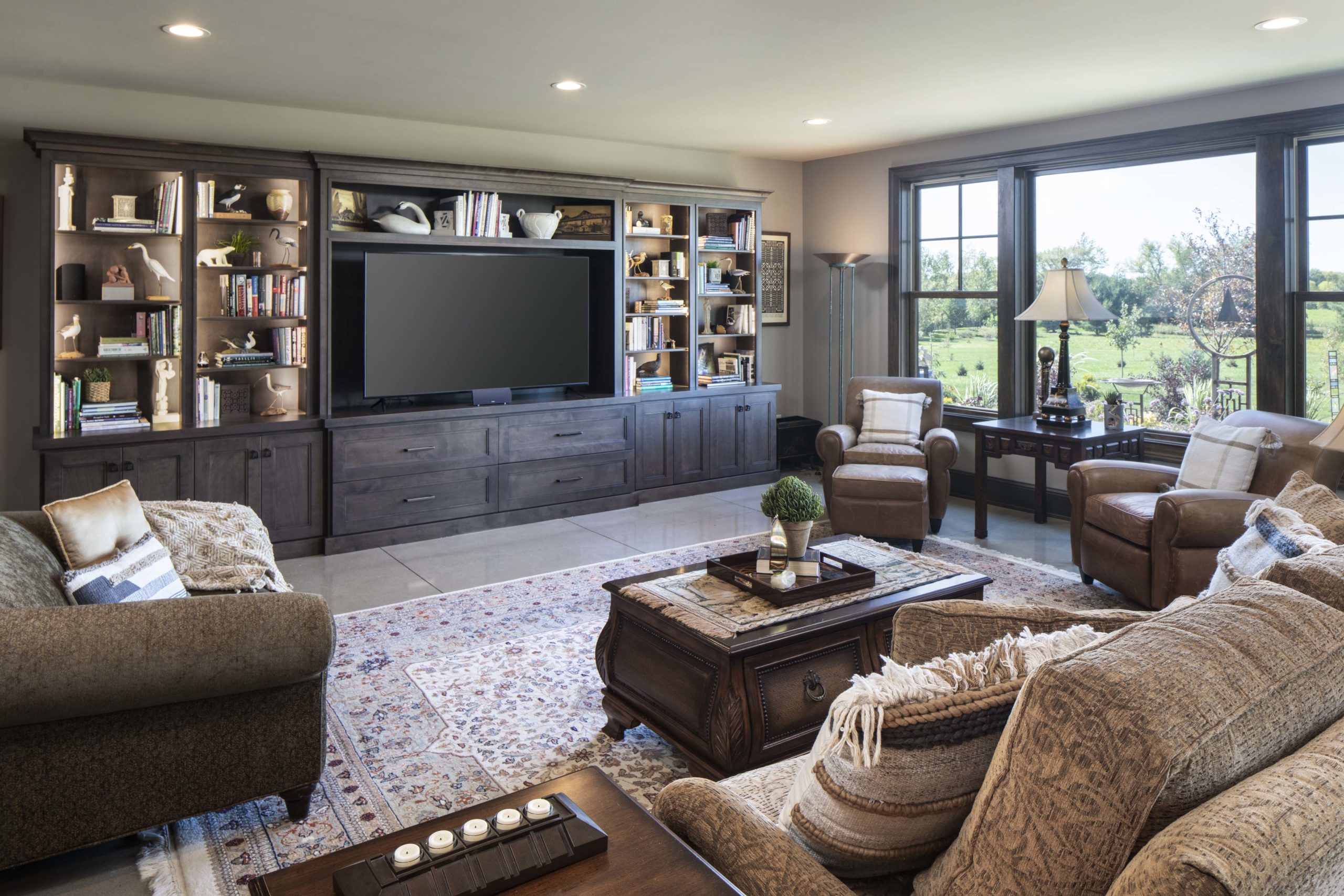 A prairie-style living room featuring comfortable couches and a sleek TV.