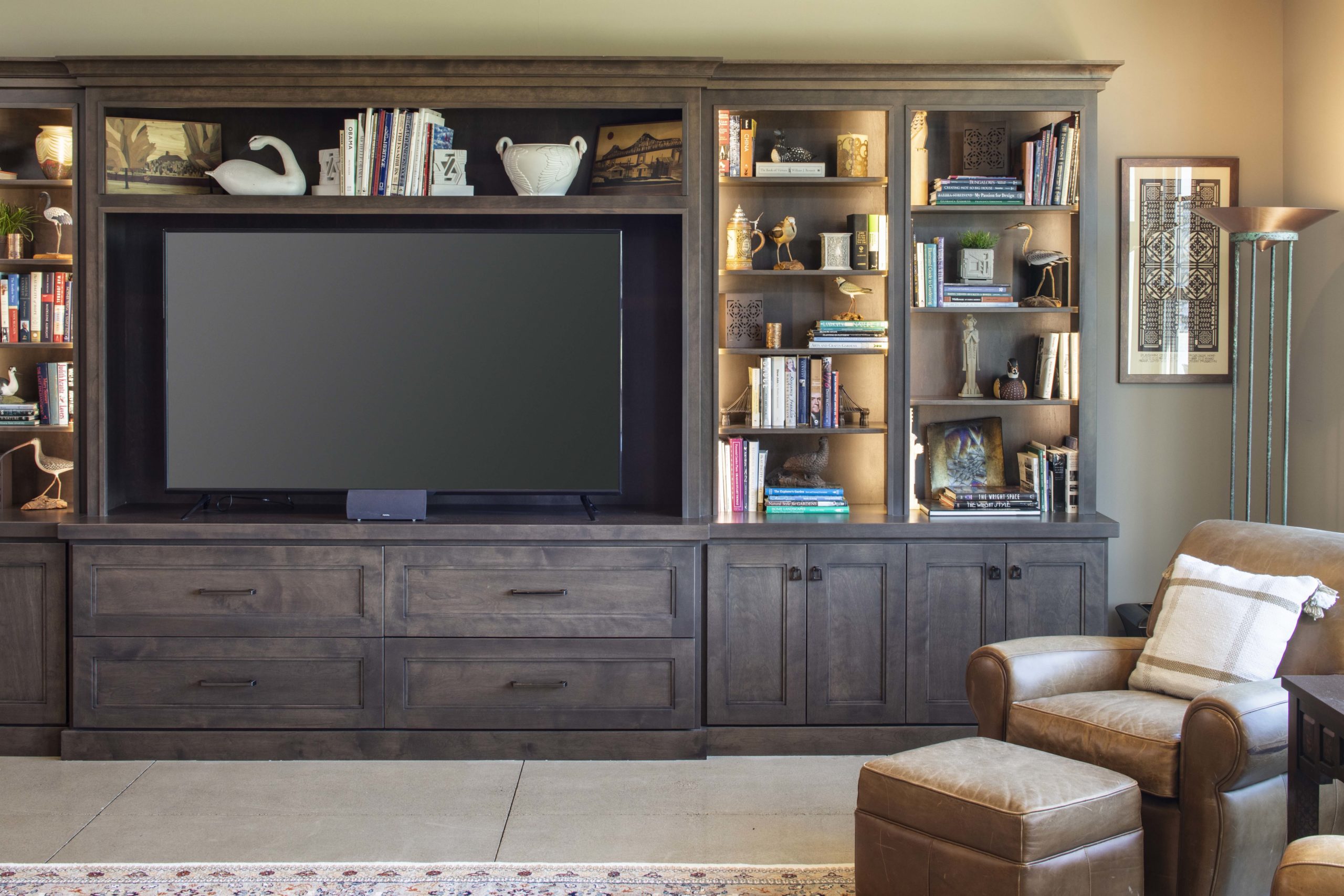 A prairie transitional living room with a tv and bookshelves.