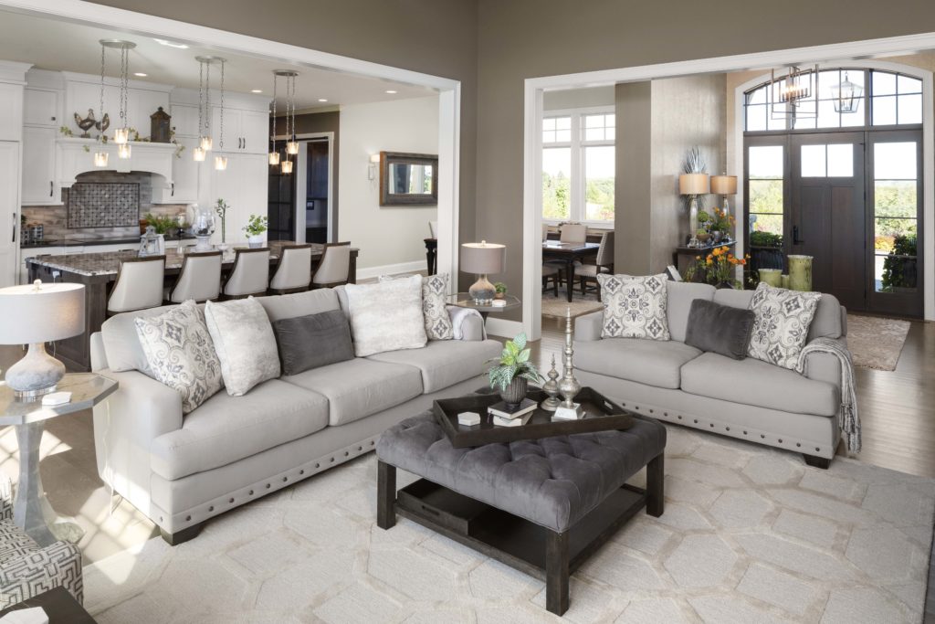 A prairie transitional living room with custom gray furniture and a coffee table.