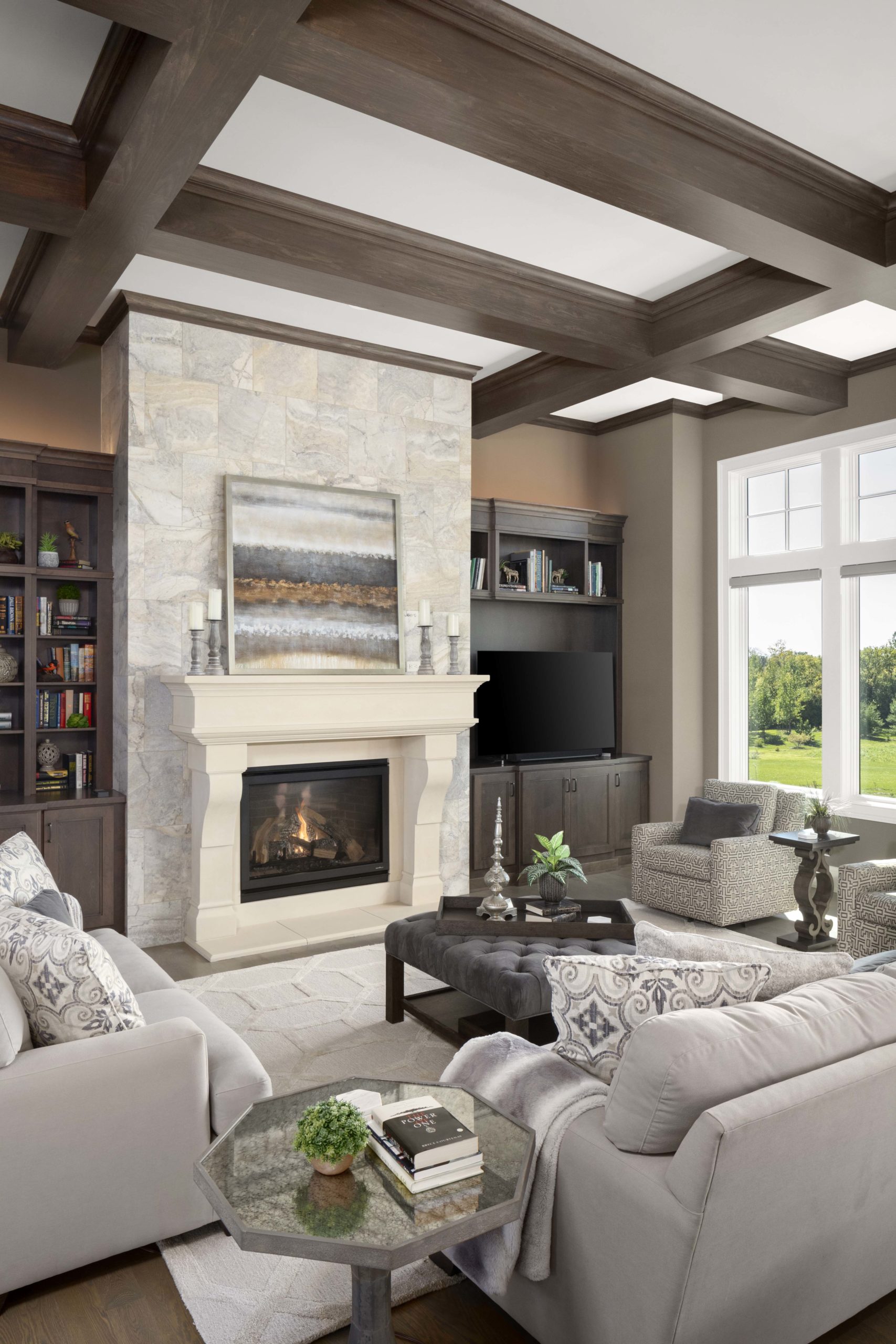 A prairie transitional living room with couches and a fireplace in a custom home.