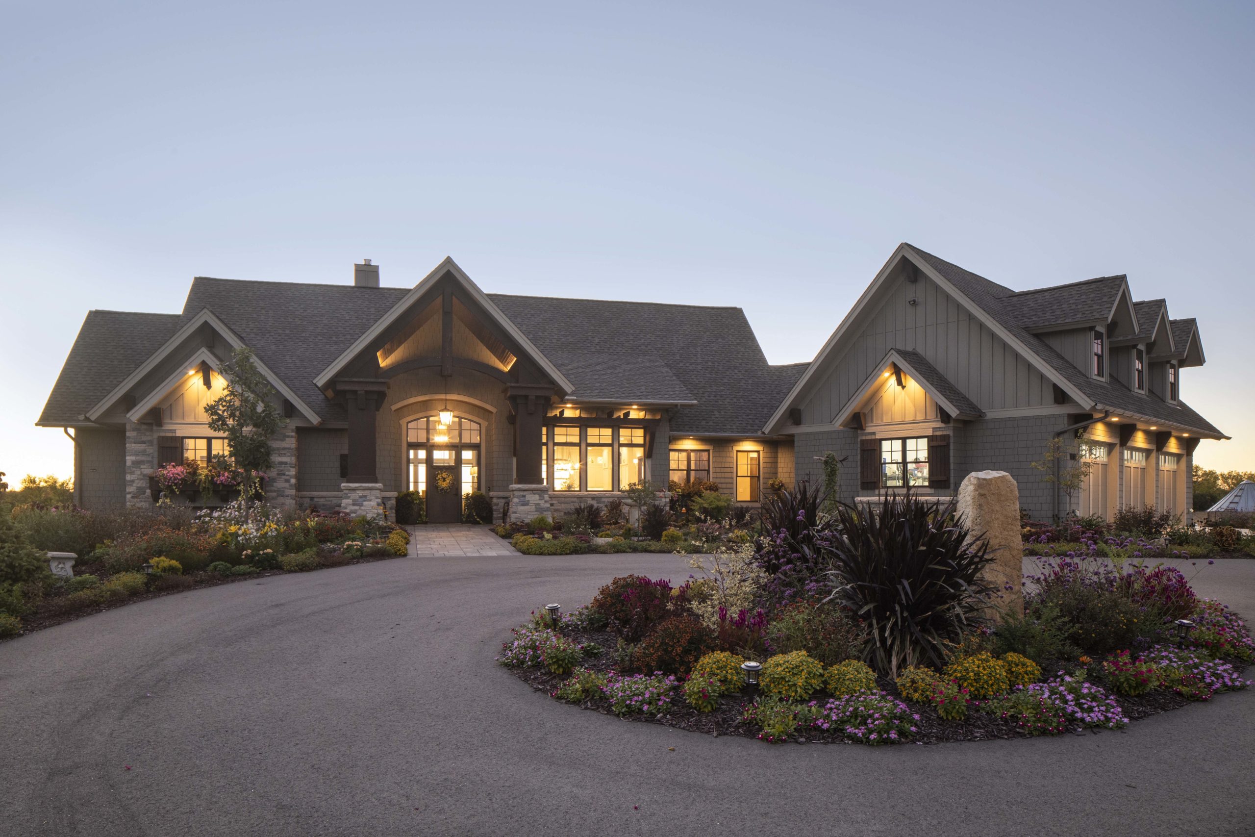 A beautiful prairie transitional custom home with exquisite landscaping and a large driveway.