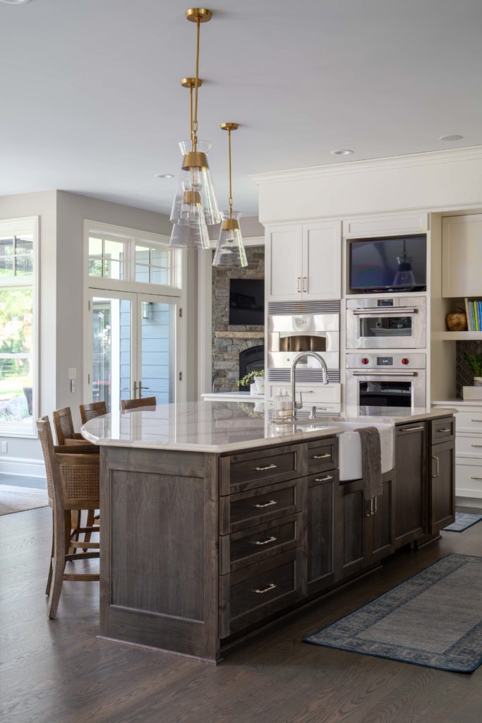 The Lake Escape custom home remodel brings you a spacious, open kitchen featuring a large island.