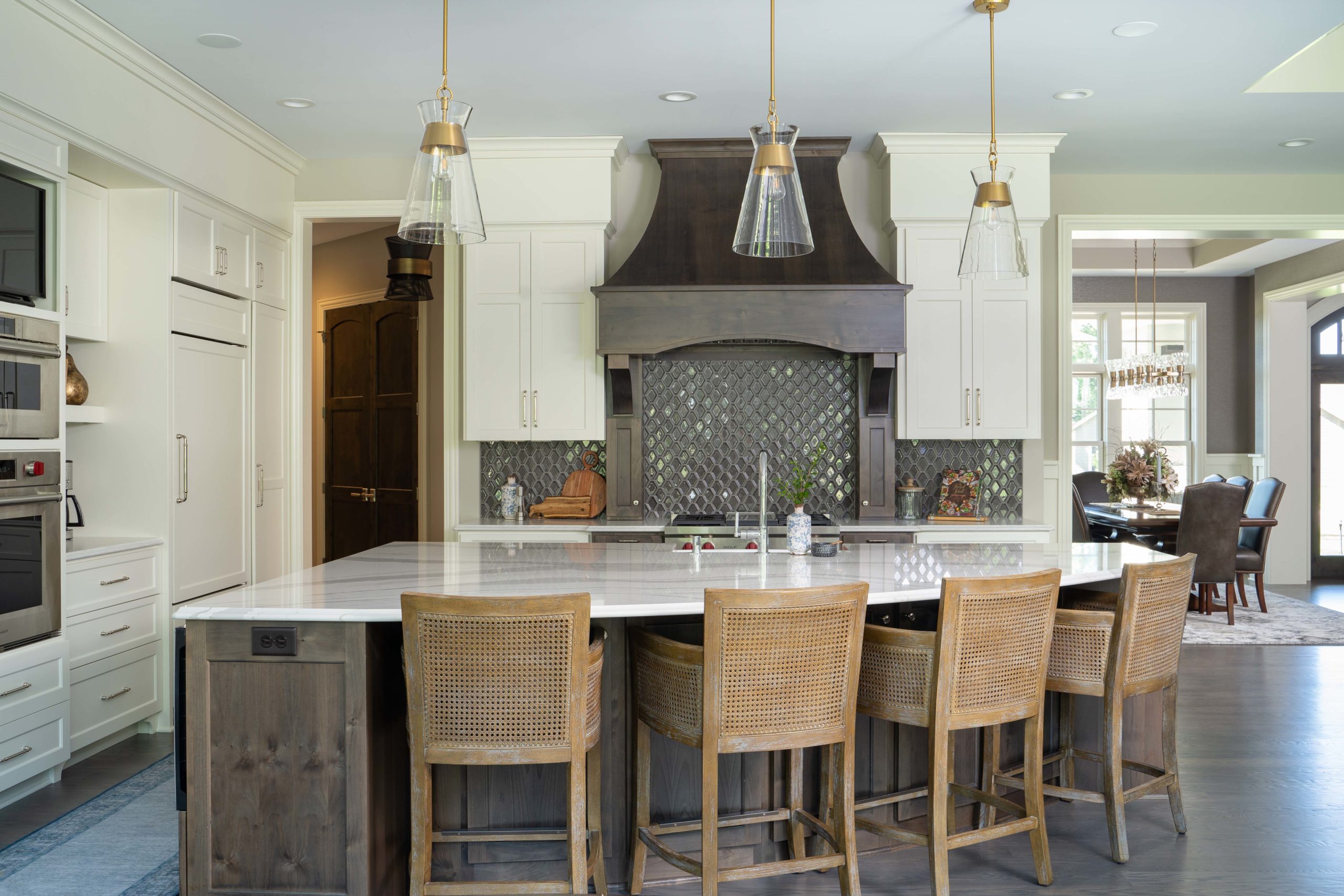 The Lake Escape custom home remodel with a kitchen featuring a center island and bar stools.