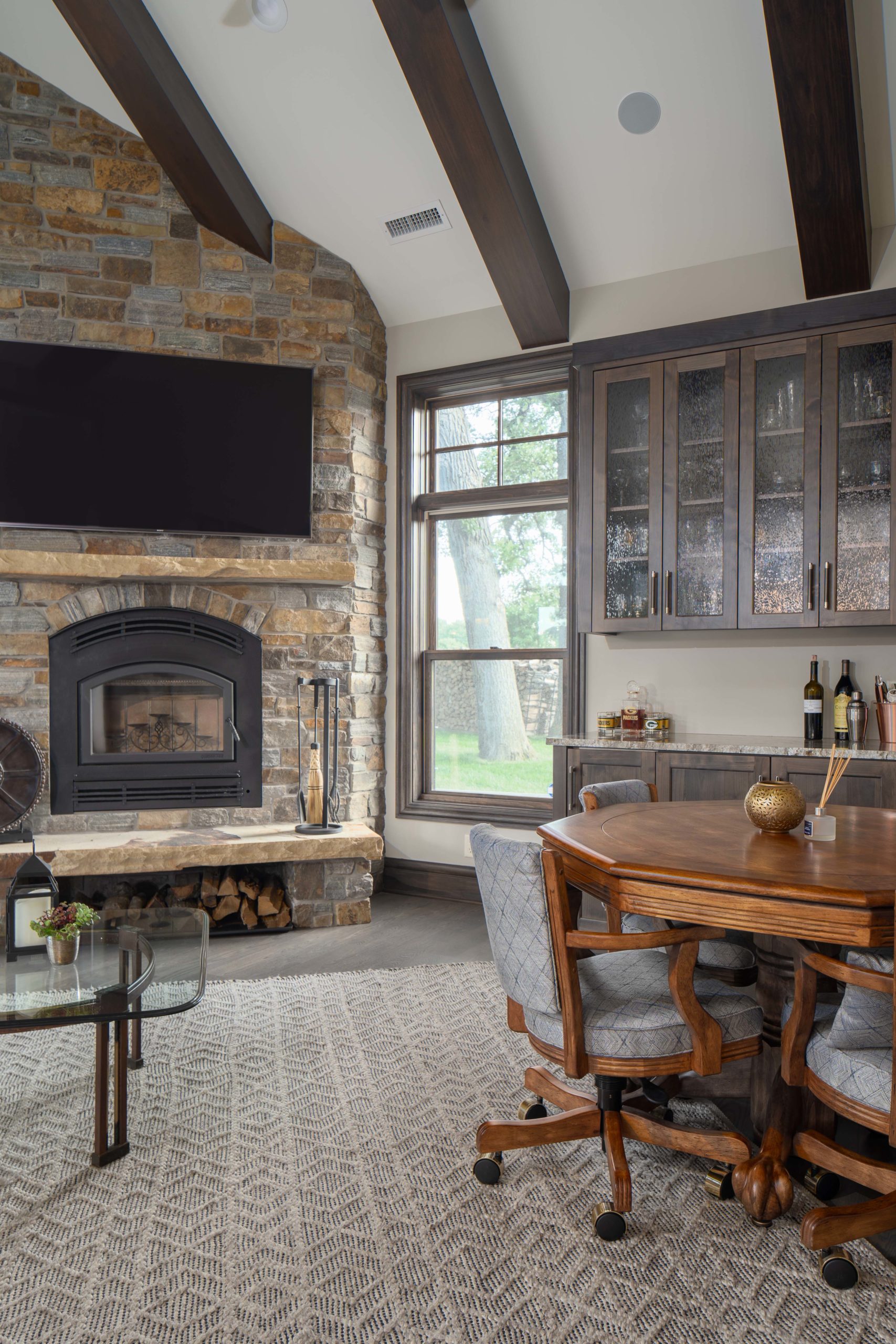 The Lake Escape custom home remodel featuring a stone fireplace in the living room.