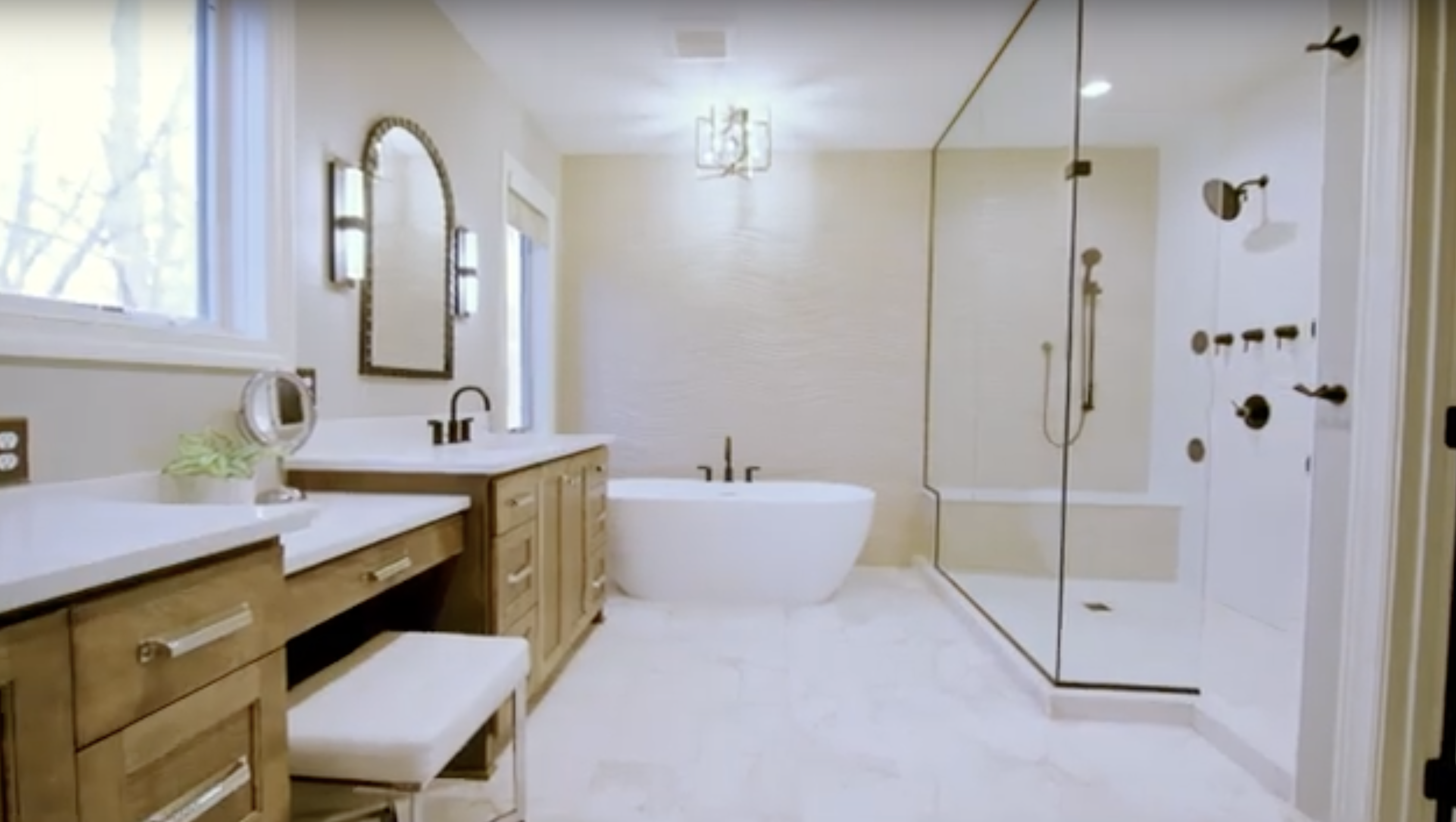 Modern Edina remodel bathroom with dual vanity, freestanding tub, and glass-enclosed shower.