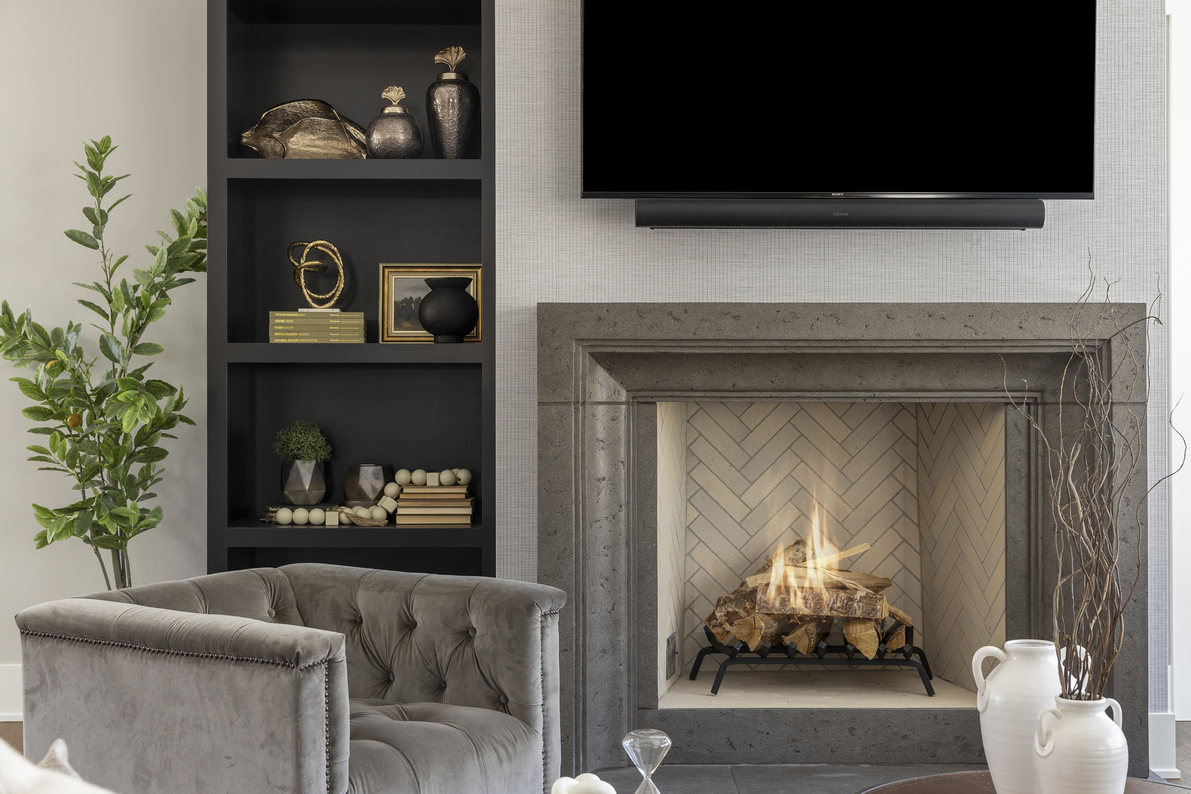 A fireplace in a living room with a tv above it.