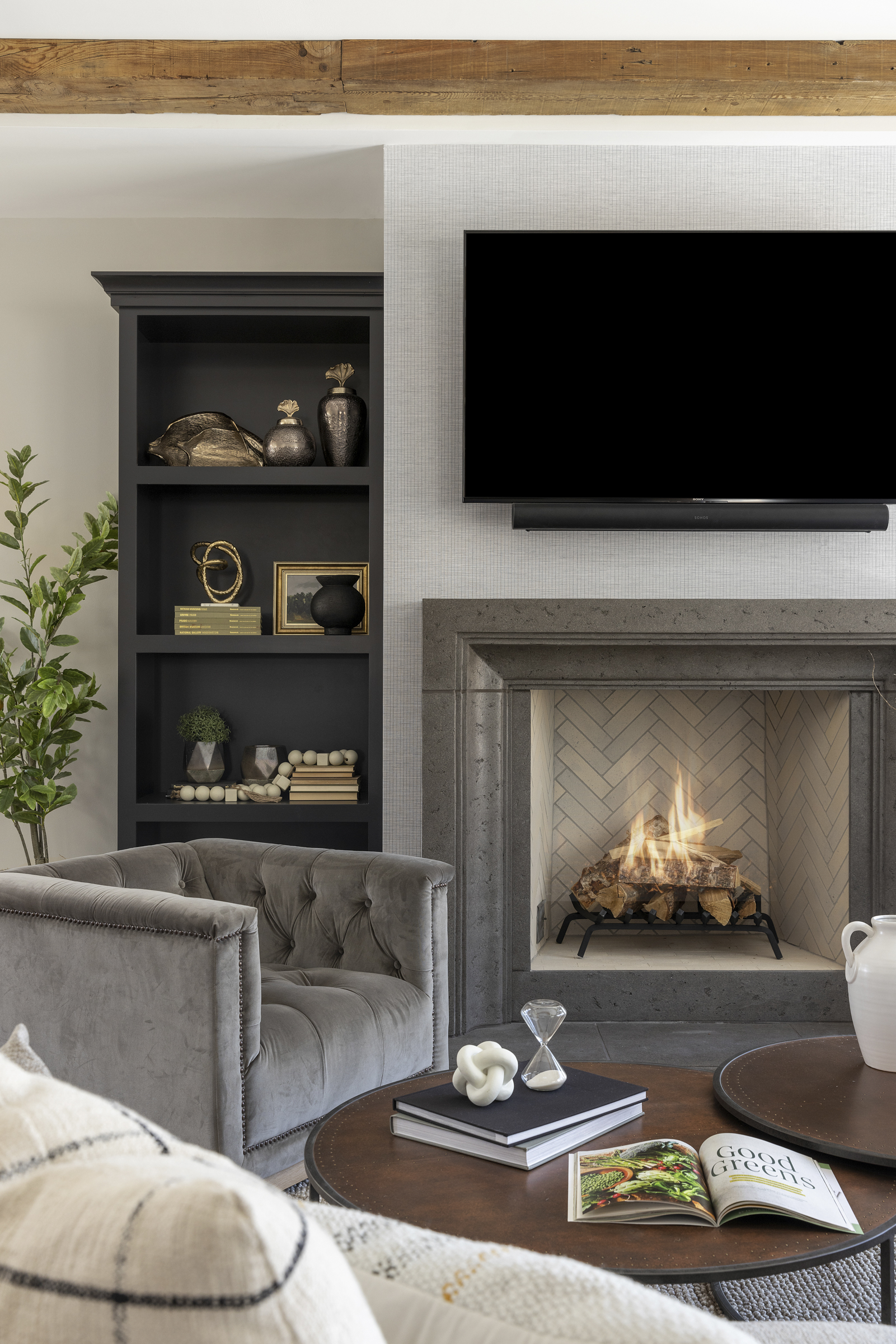A living room with a tv above the fireplace.