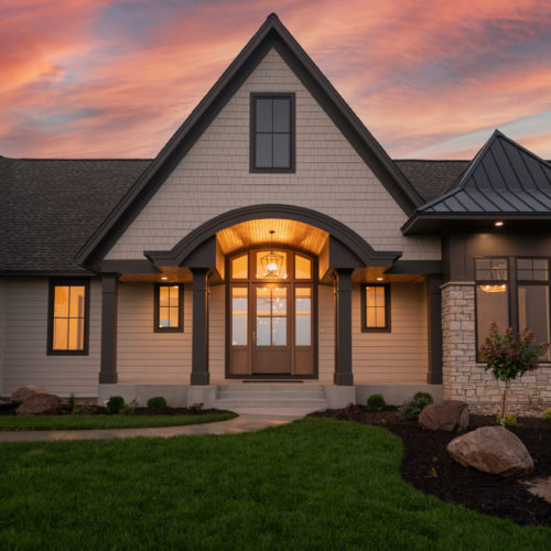 The custom exterior of a prairie transitional home at dusk.