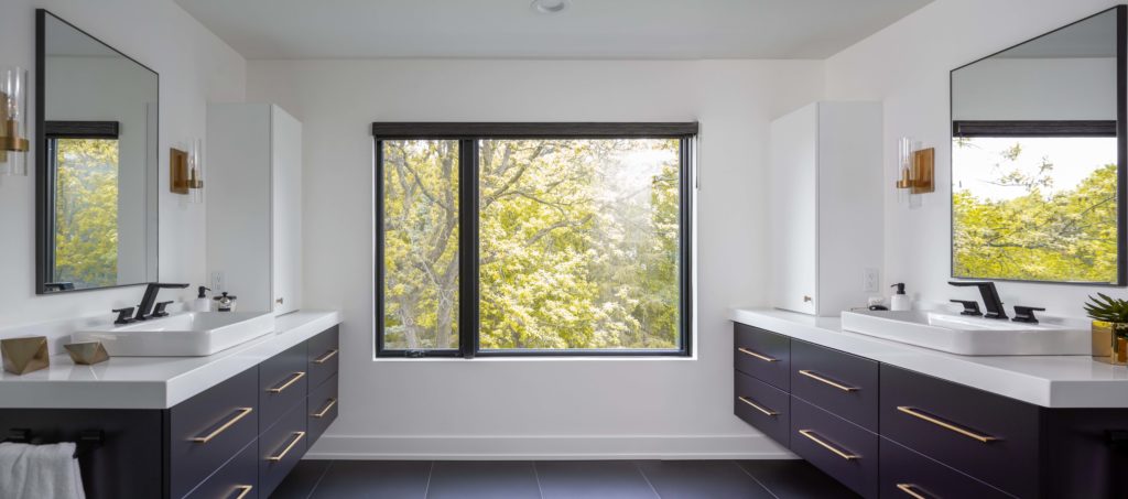 A modern bathroom remodel featuring two sinks and a window.