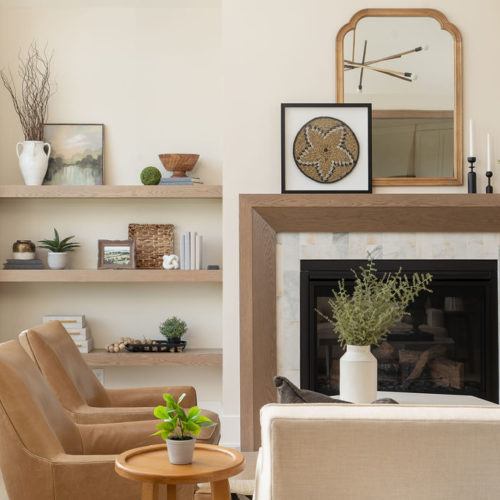 A prairie transitional living room with a fireplace and custom bookshelves.
