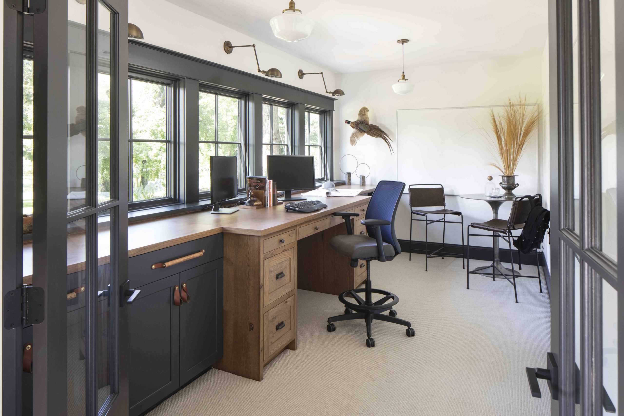 A prairie transitional home office with a desk and chairs.