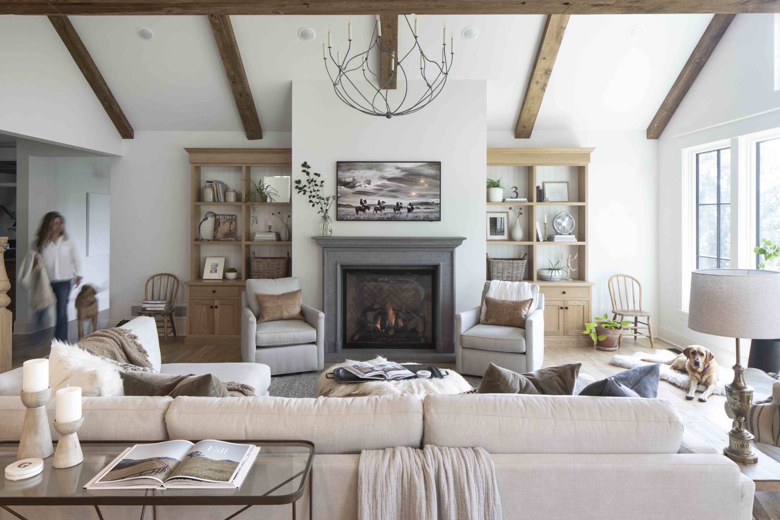 A prairie transitional custom home with wood beams and a fireplace.