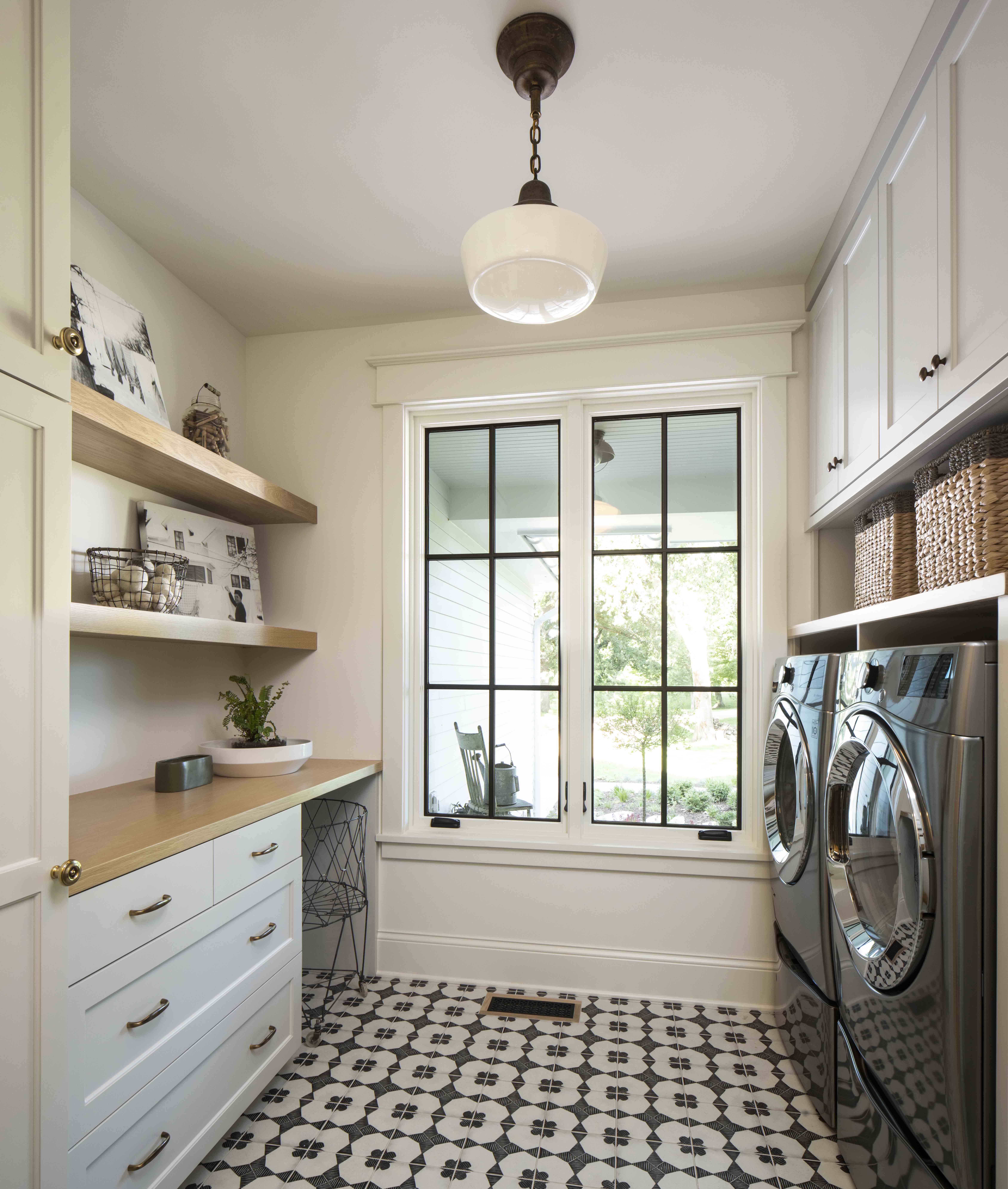 A prairie-style transitional custom home with a laundry room equipped with a washer and dryer.