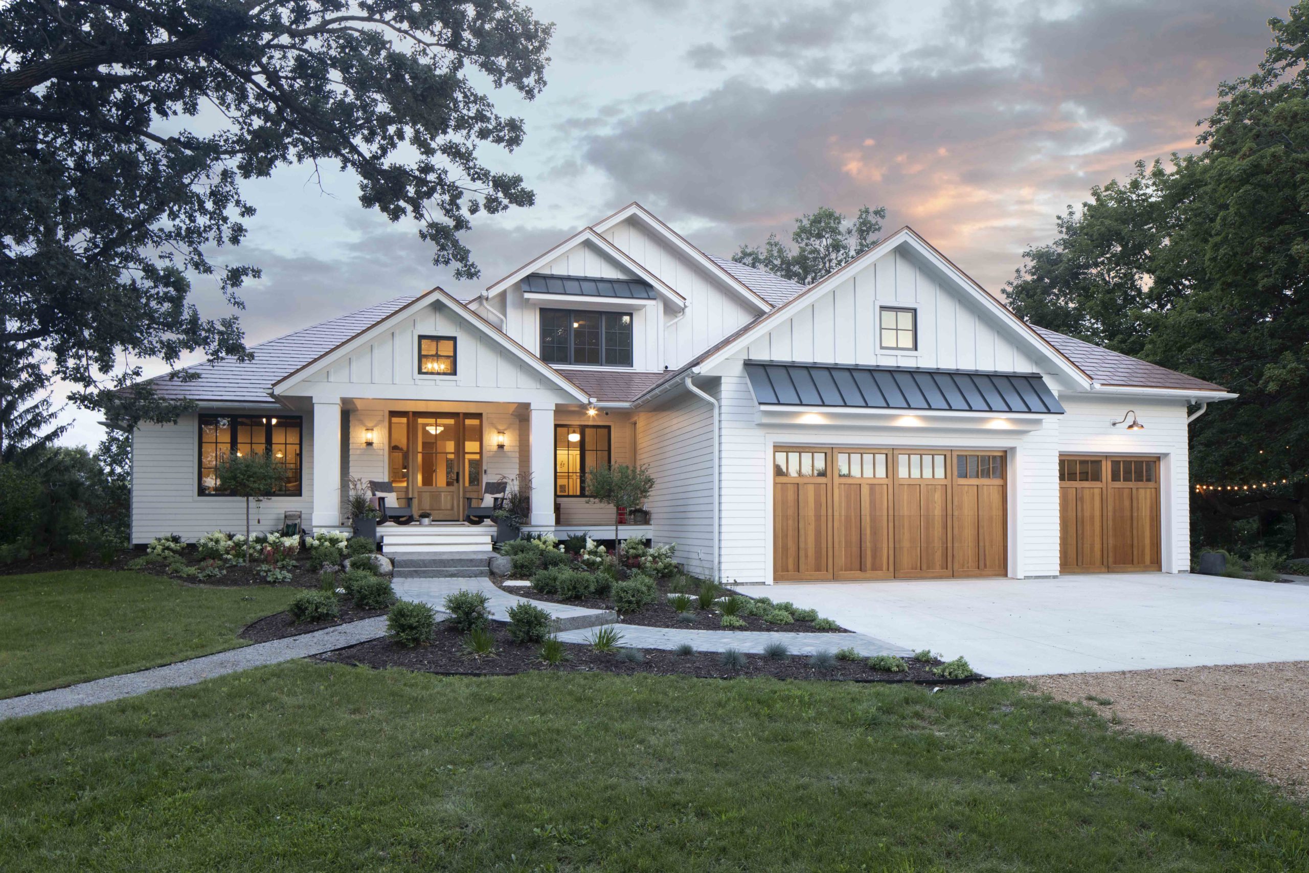 A prairie-style home with a white exterior and large garage.