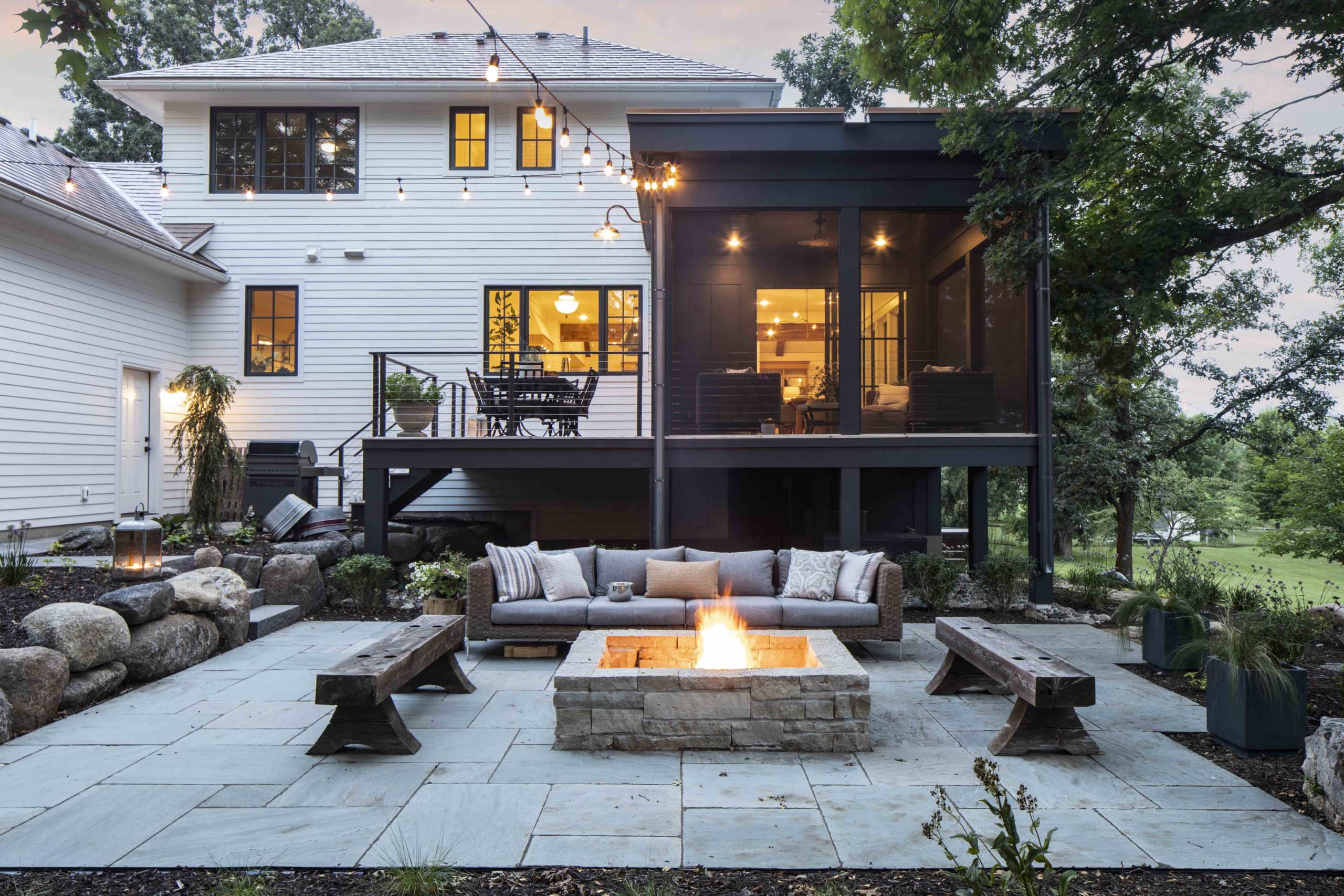 A prairie-style backyard with a fire pit and seating area in a custom home.