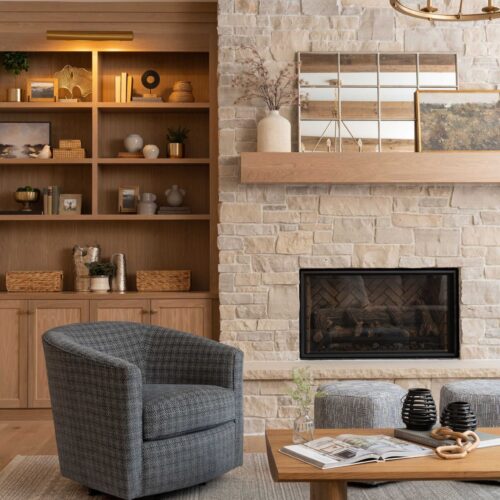 An inviting Eden Prairie living room featuring a stone fireplace and wooden beams.