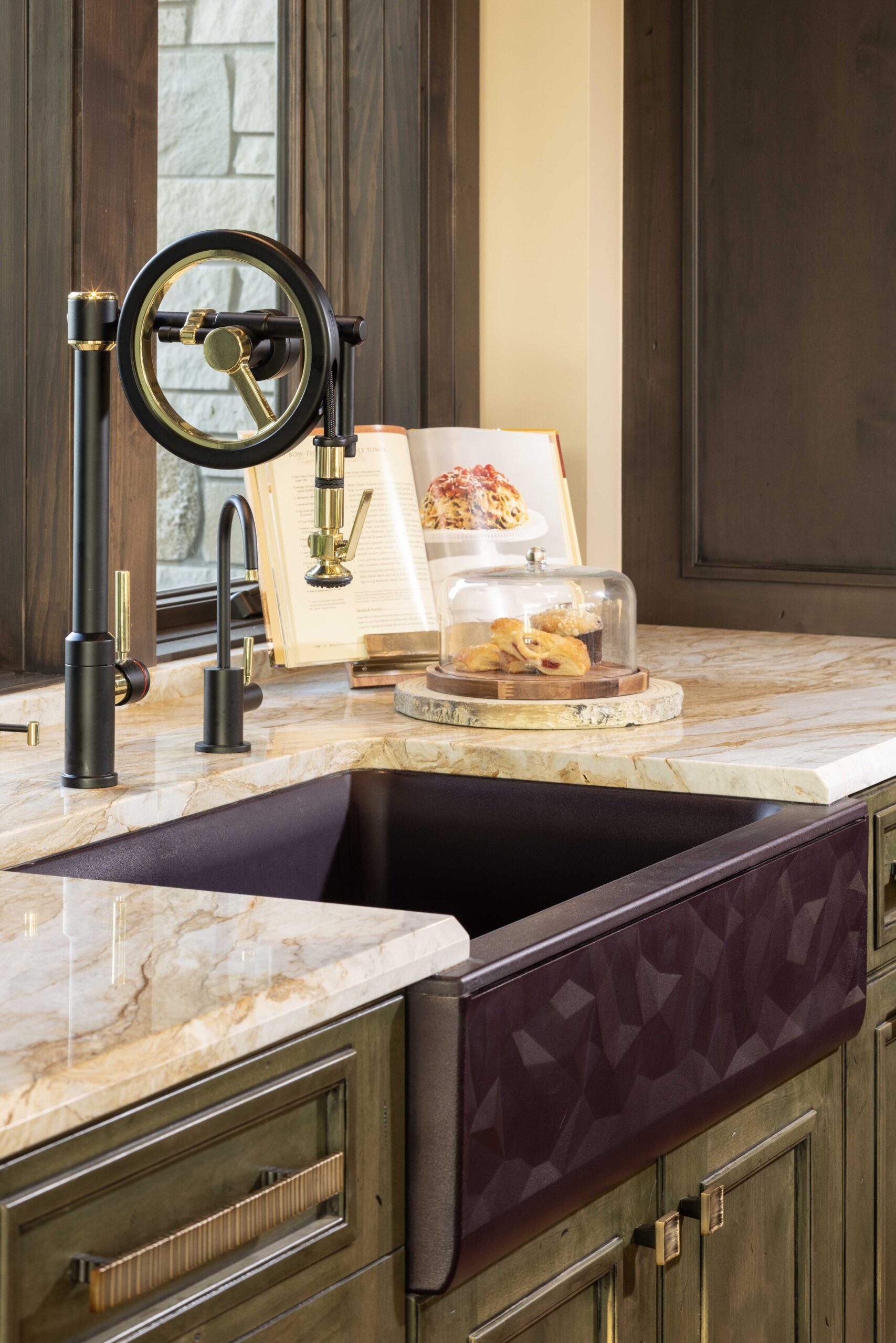 A modern kitchen sink in a Tuscan-style home.