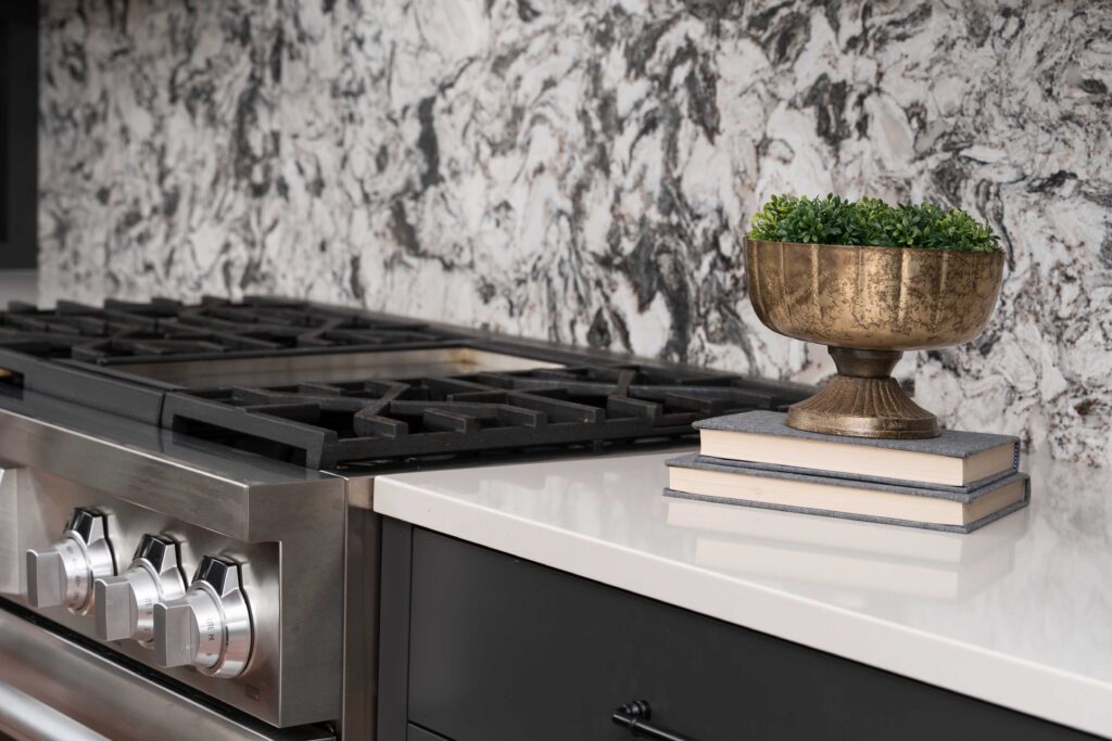 A modern kitchen with a marble stove top.