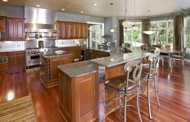 A large kitchen with hardwood floors and a contemporary center island.