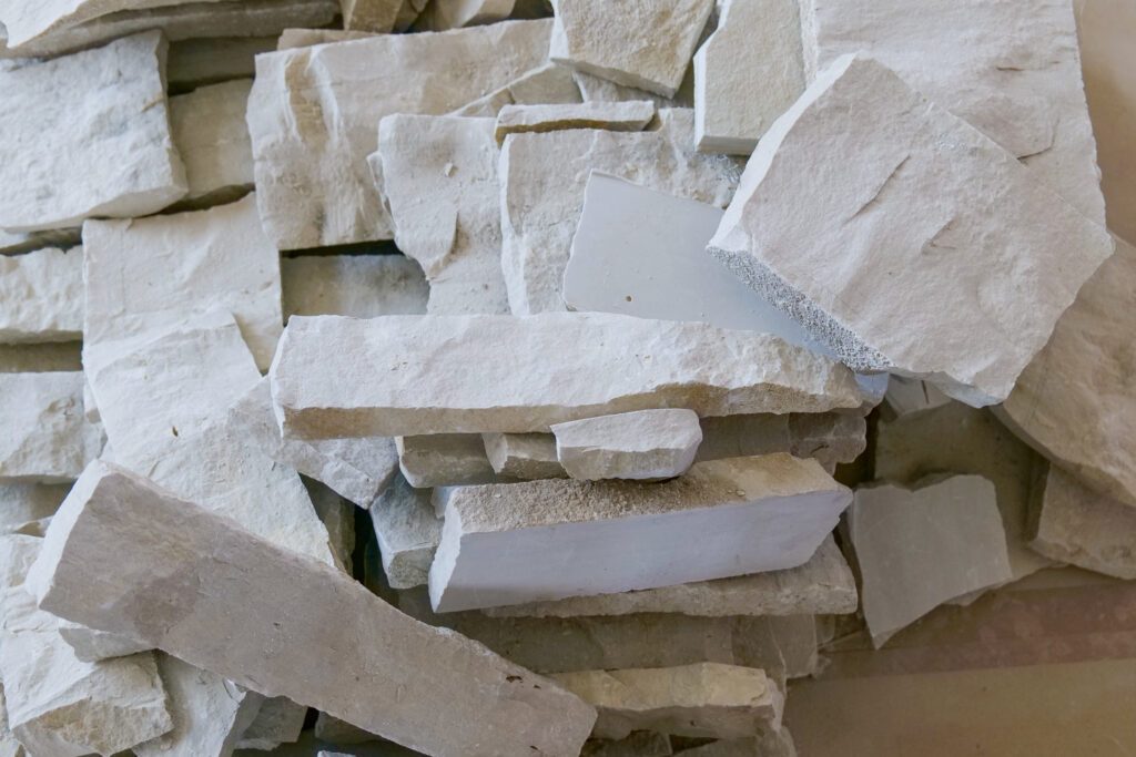 A pile of white stones on a table in a Modern Tuscan Mediterranean home.