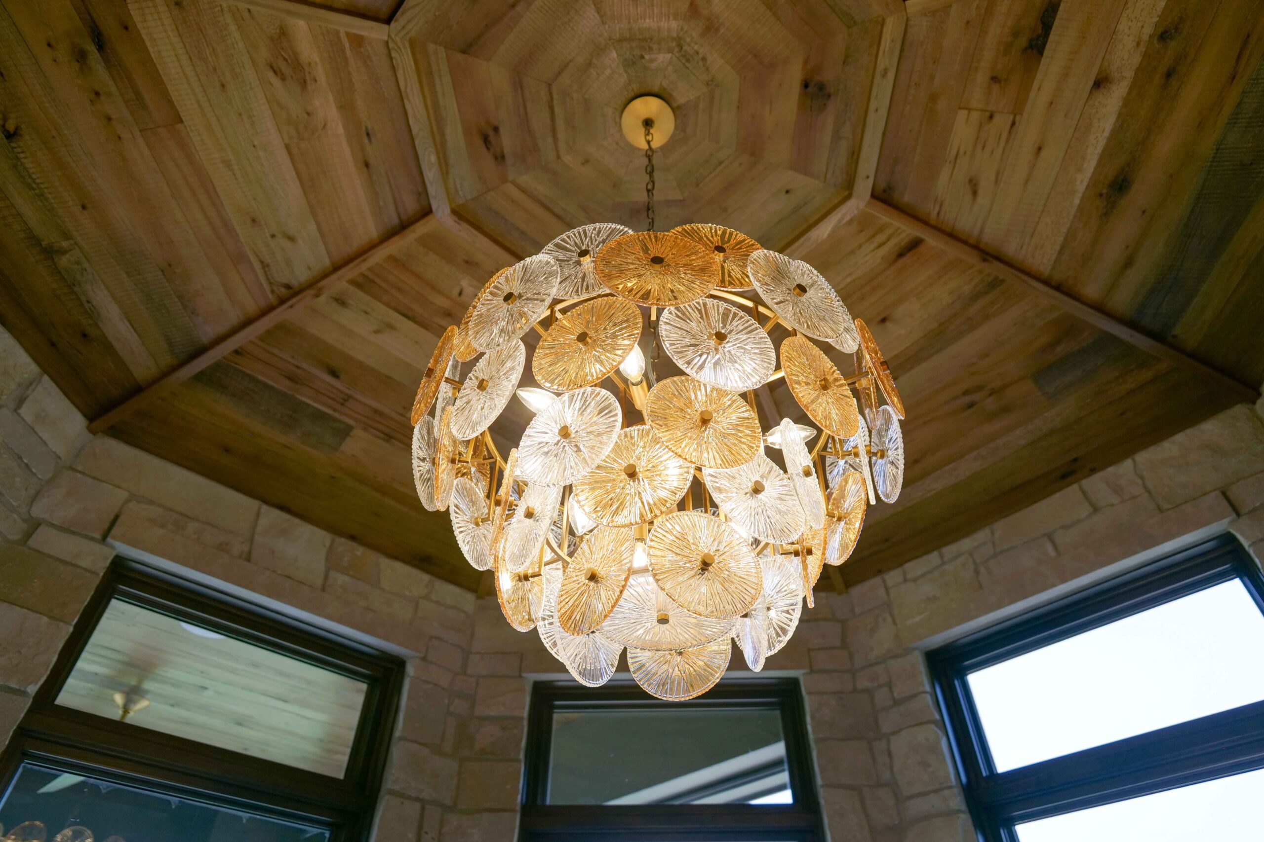 A large chandelier hanging from a ceiling in a modern home.