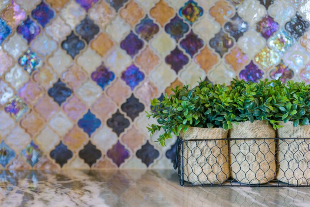 Three potted plants in a basket on a countertop in a Modern Tuscan home.