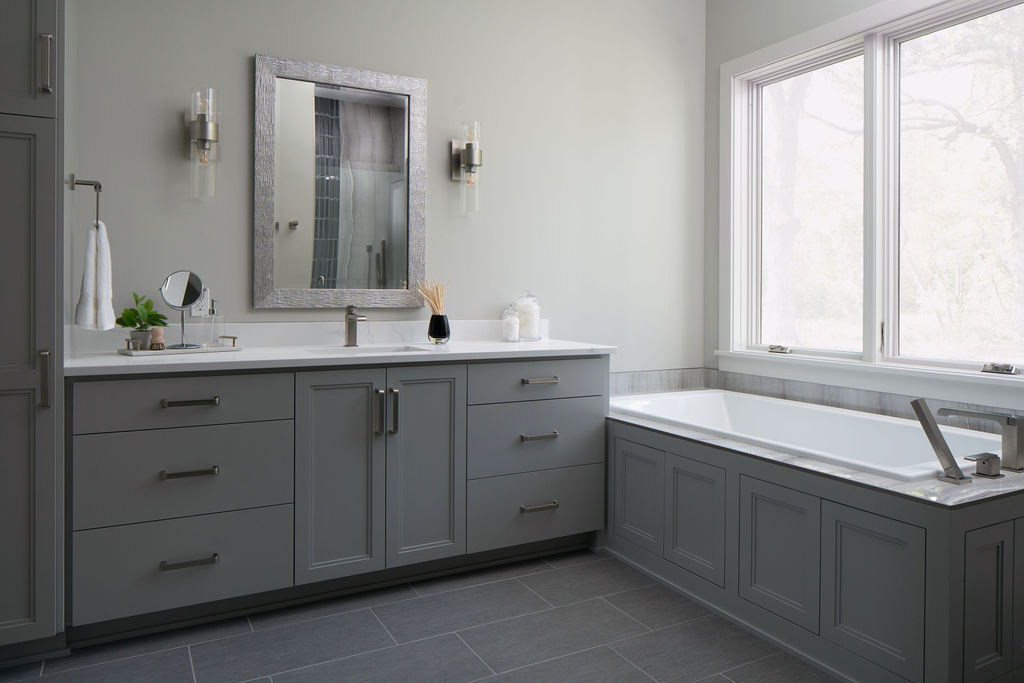 A Transitional Farmhouse gray bathroom with a tub and sink.