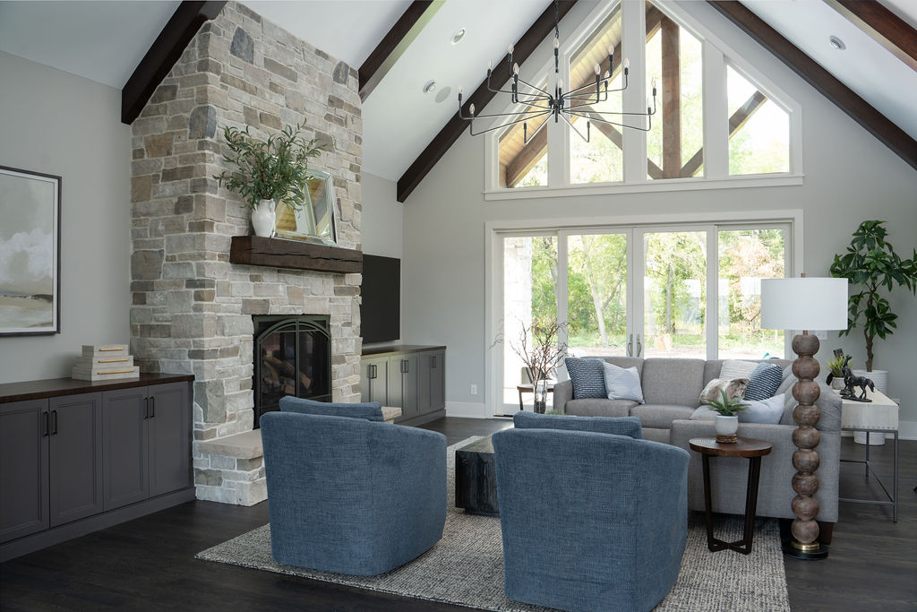 A transitional living room with a stone fireplace.