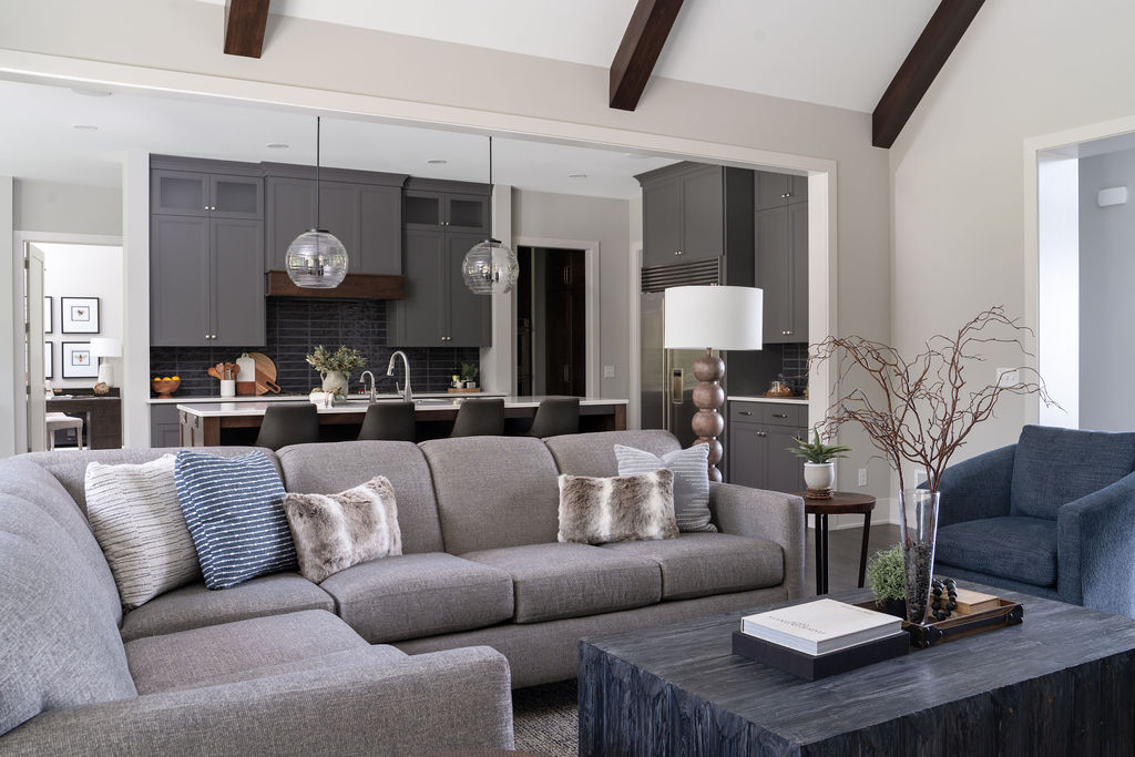 A transitional living room with a gray couch and coffee table.