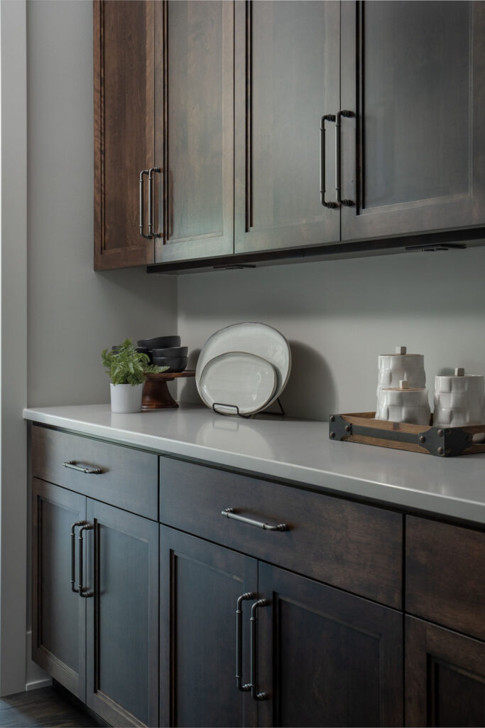 A transitional kitchen with dark wood cabinets and counter tops.