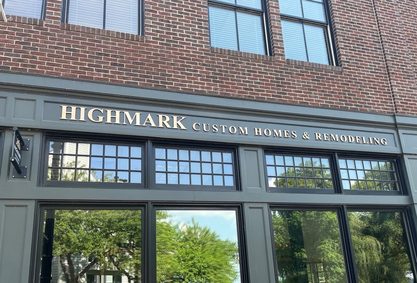 A building with a sign that says Highmark Custom Homes and Remodeling, located in The Ranch.