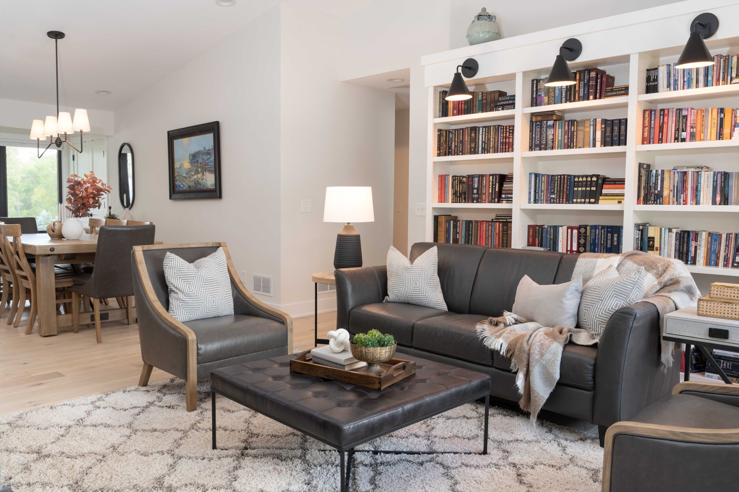 Orchard Lake Remodel: A living room with a coffee table and bookshelves.