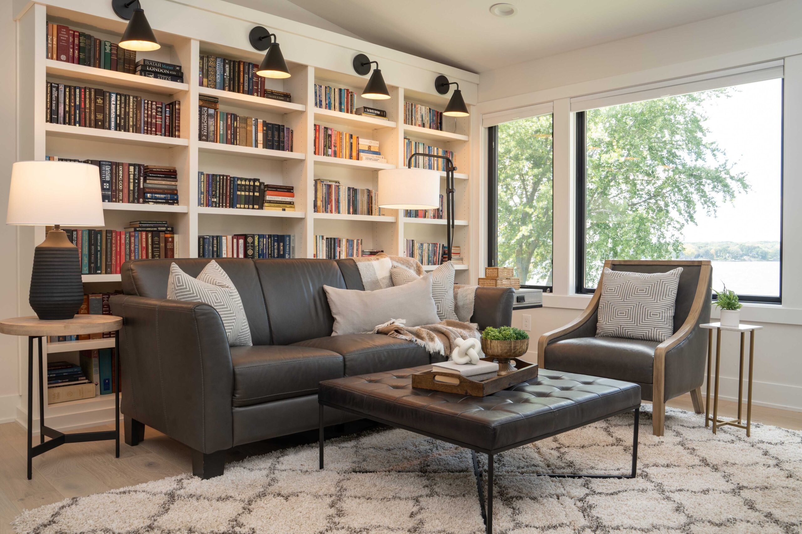 An Orchard Lake Remodel living room with a couch, coffee table and bookshelves.