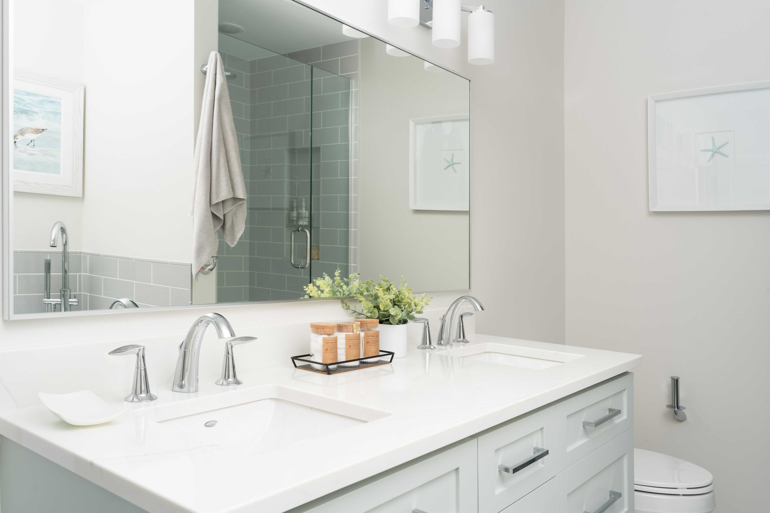 An Orchard Lake remodel with a white bathroom featuring a large mirror and sink.