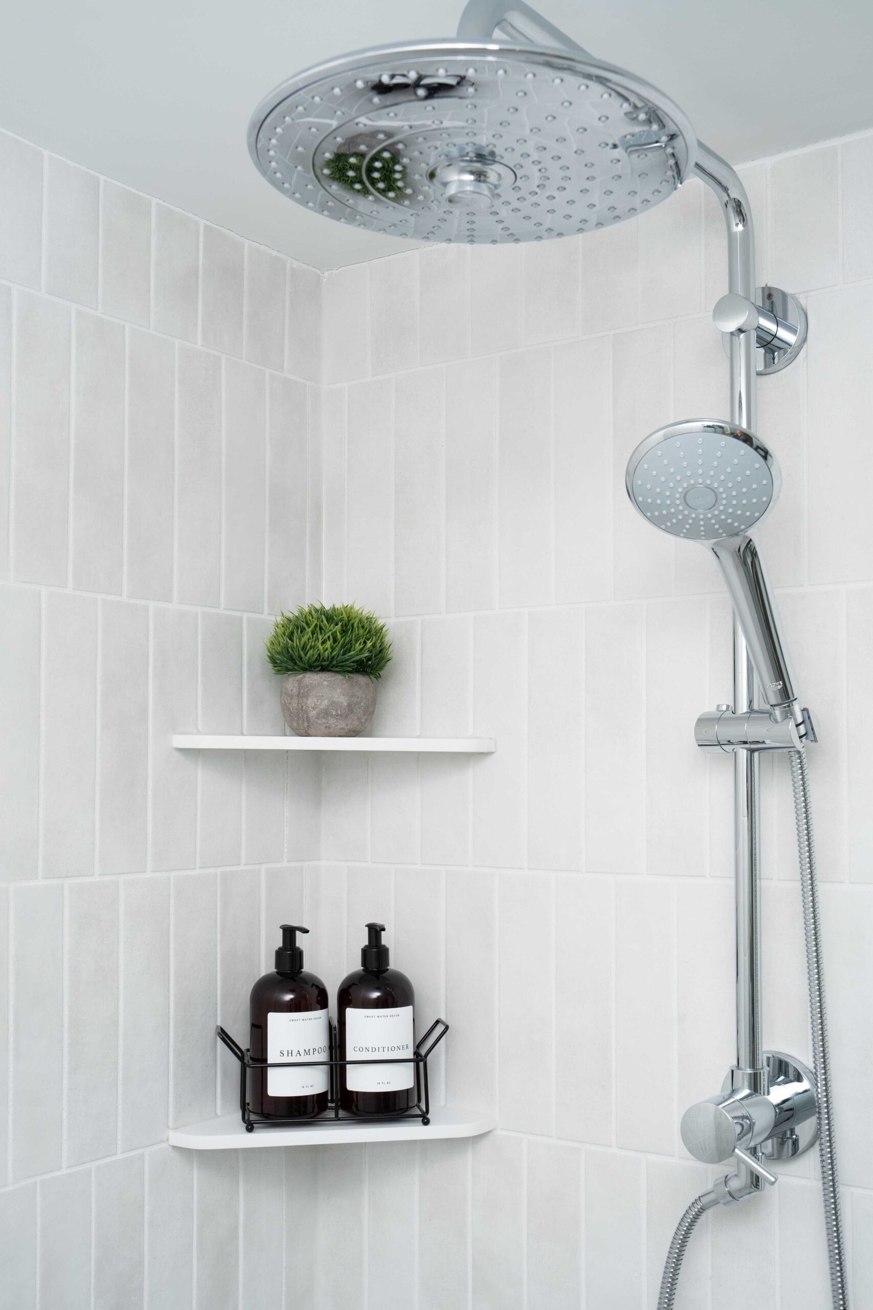 Orchard Lake Remodel: A bathroom with a shower head and a shelf.
