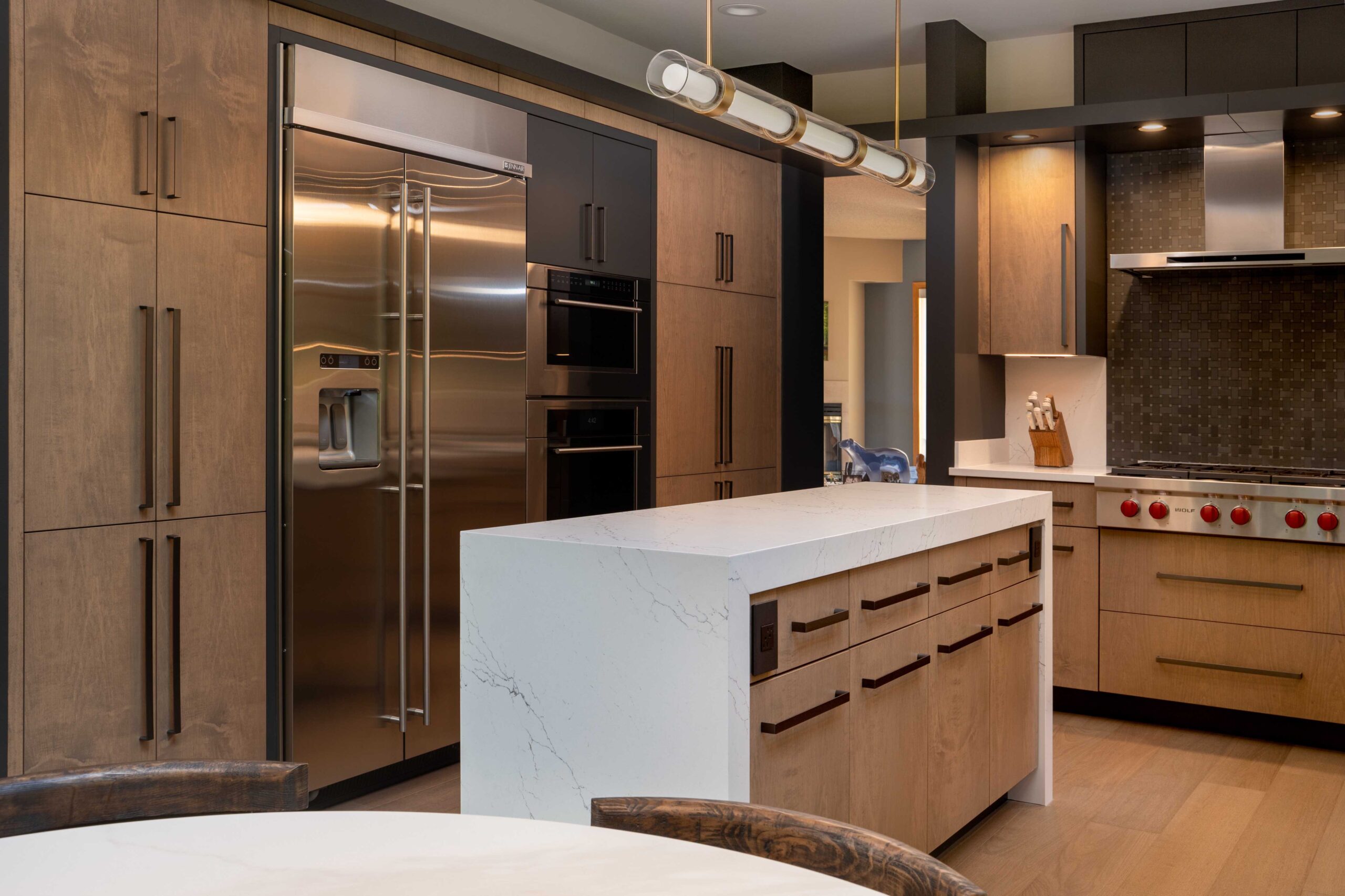 A modern kitchen with wooden cabinets and stainless steel appliances, perfect for a Bloomington remodel.